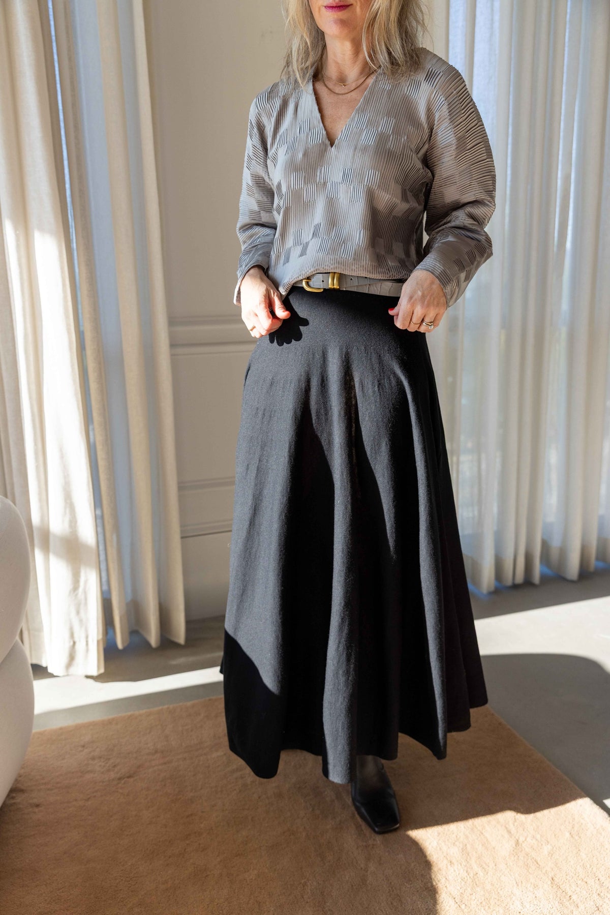 by Malene Birger Franca Top in paloma grey pleated satin with the black Geri Skirt and Zoilo Belt, full-length view