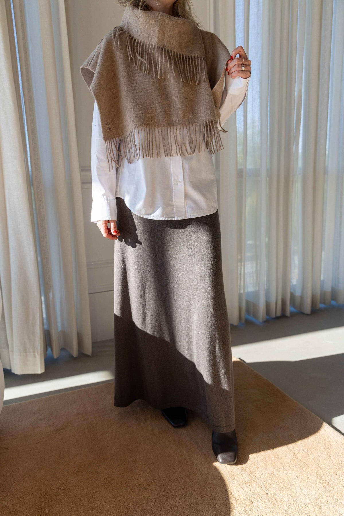 by Malene Birger Turtla in Grey Brown Melange over a white shirt and brown maxi skirt, full-length view
