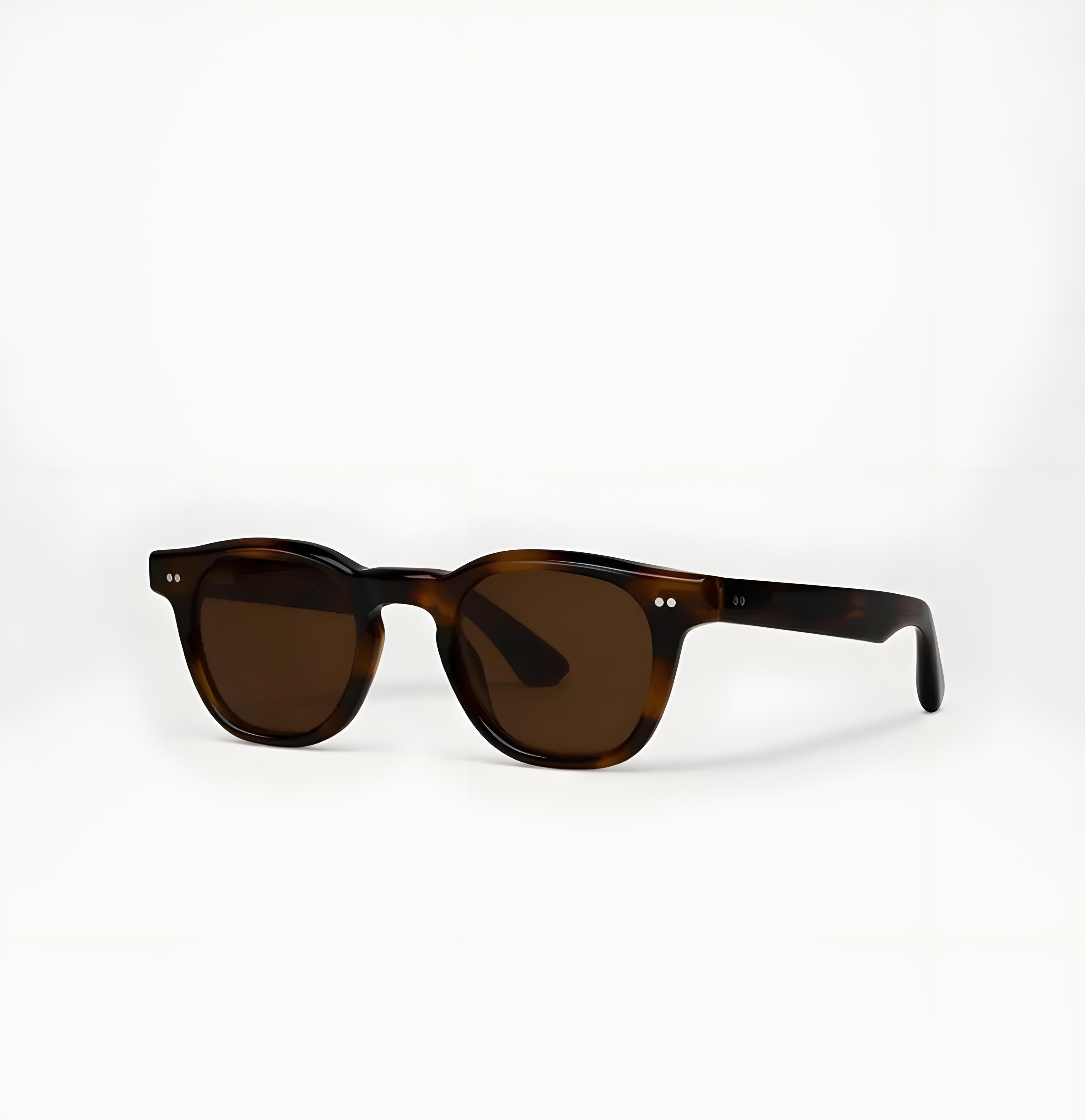 Sunglasses with tortoiseshell frame and green lenses on a white background