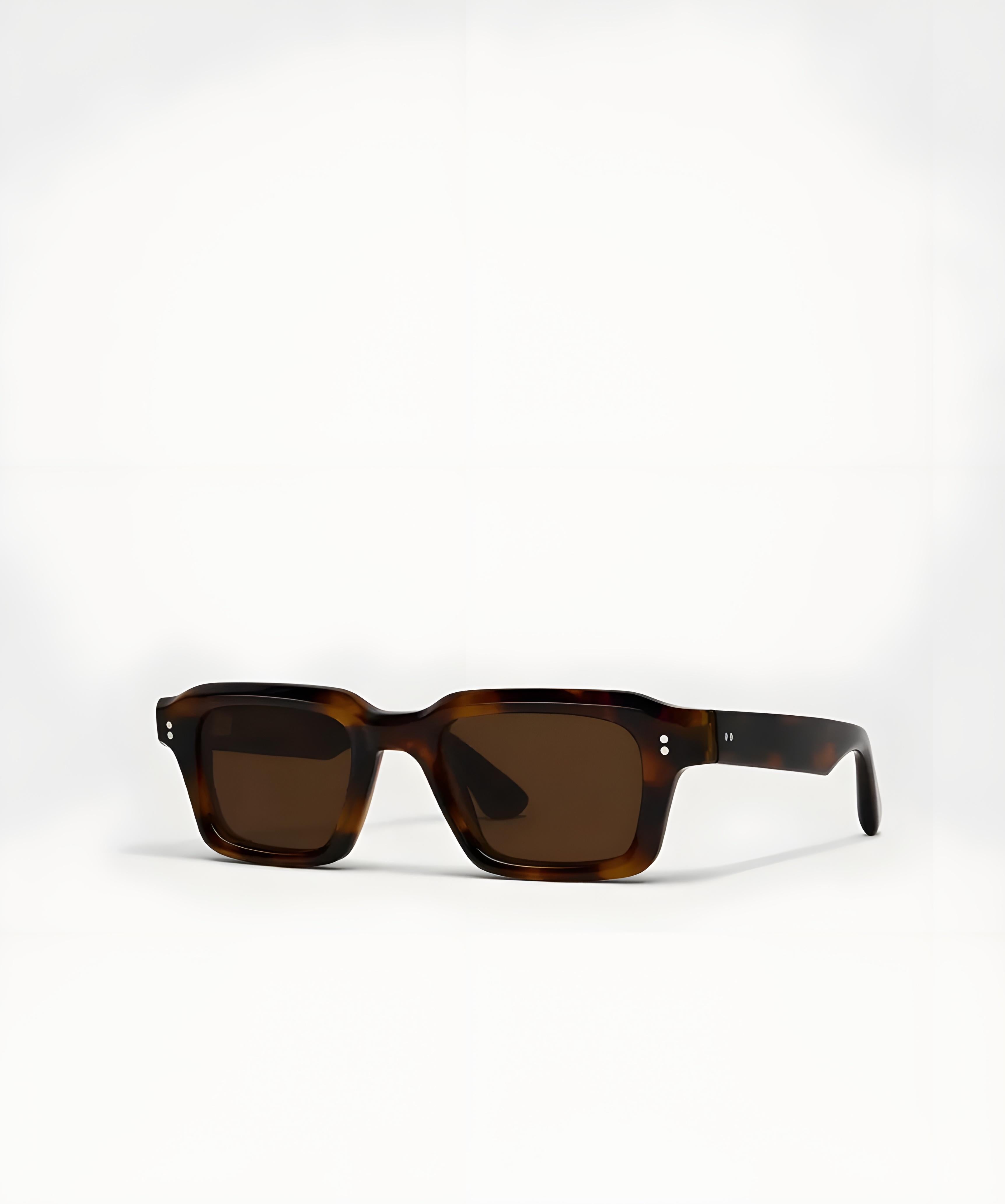 Sunglasses with tortoiseshell frame and brown lenses on a white background