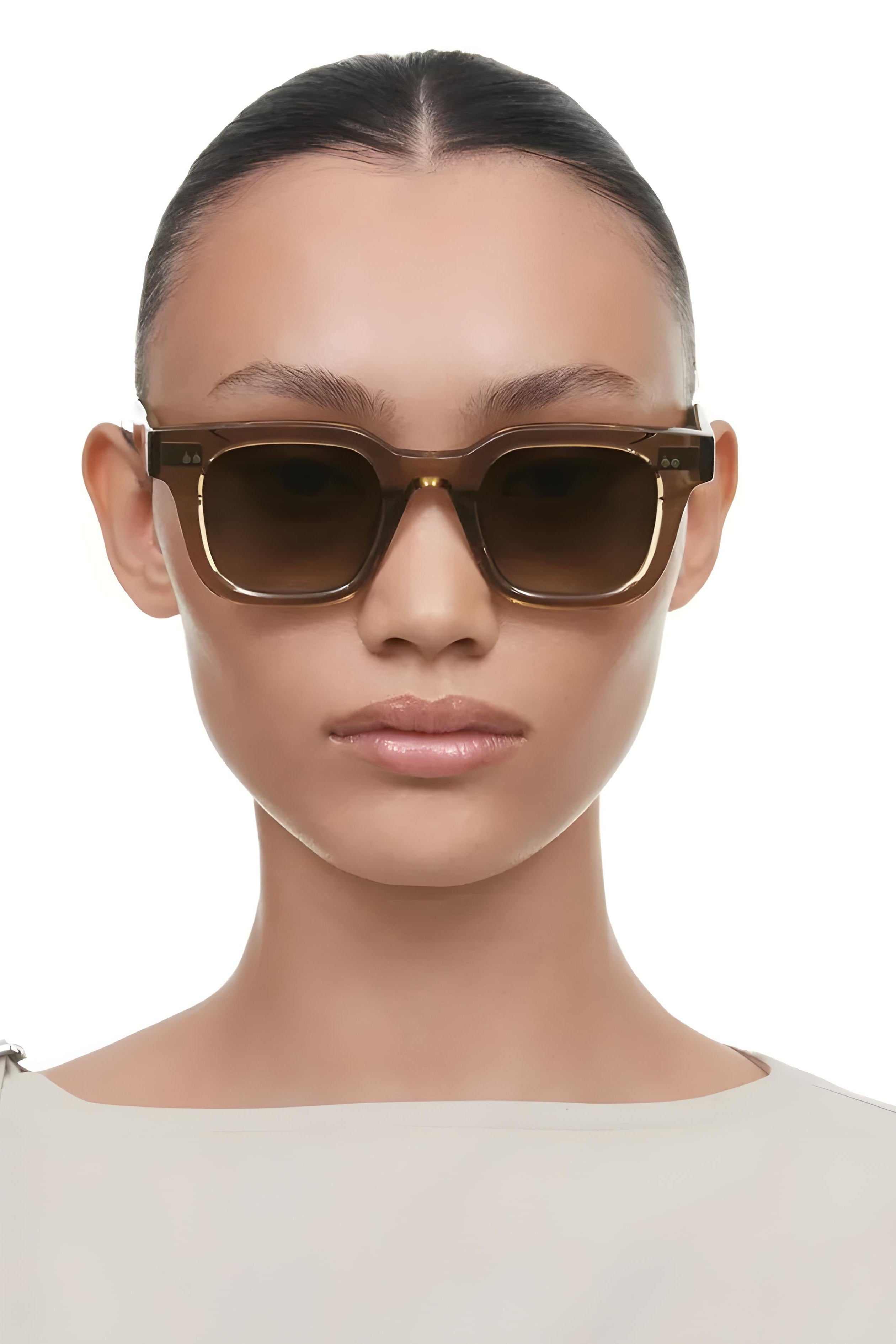Person wearing brown sunglasses on a white background