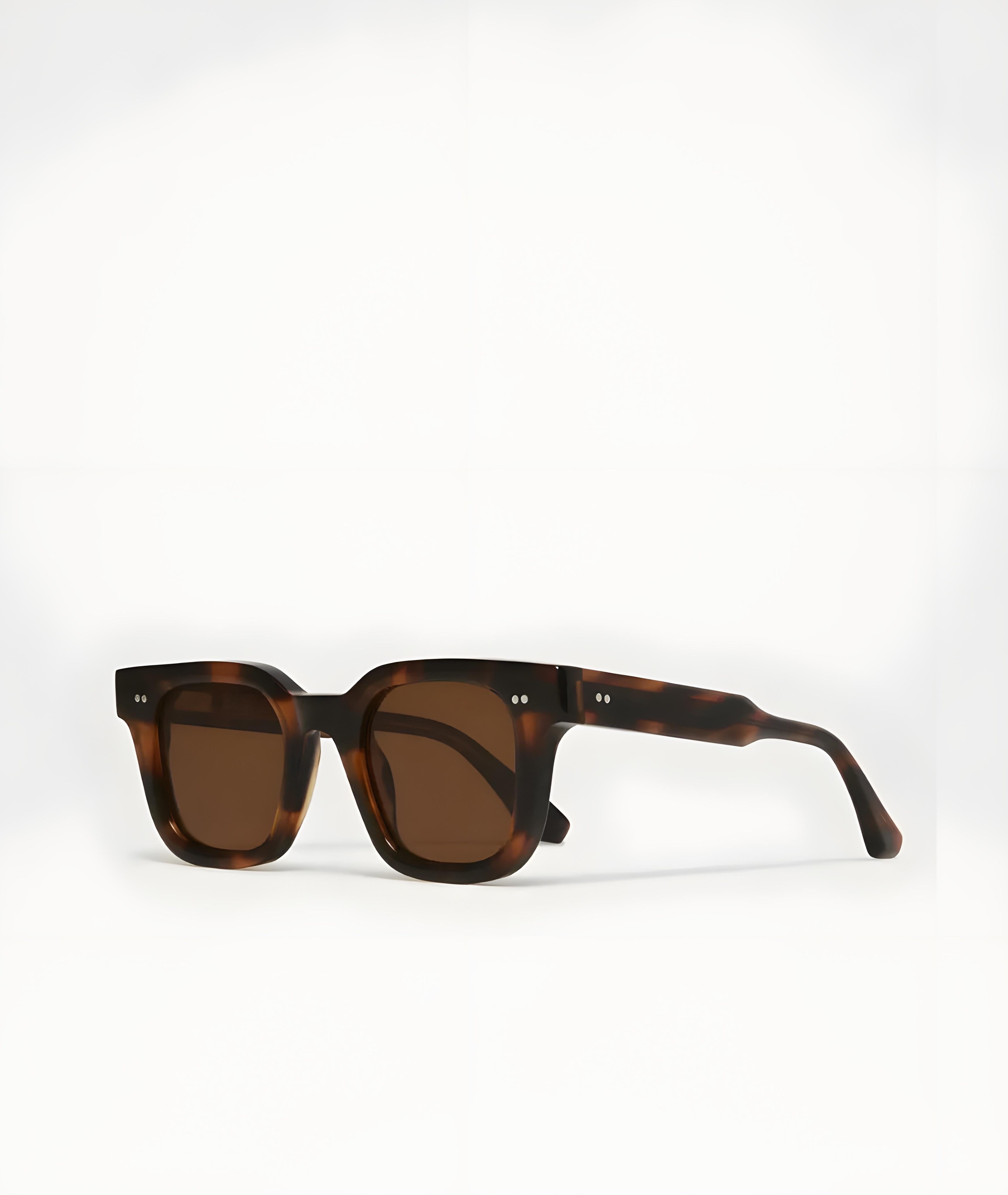 Sunglasses with tortoiseshell frame and brown lenses on a white background