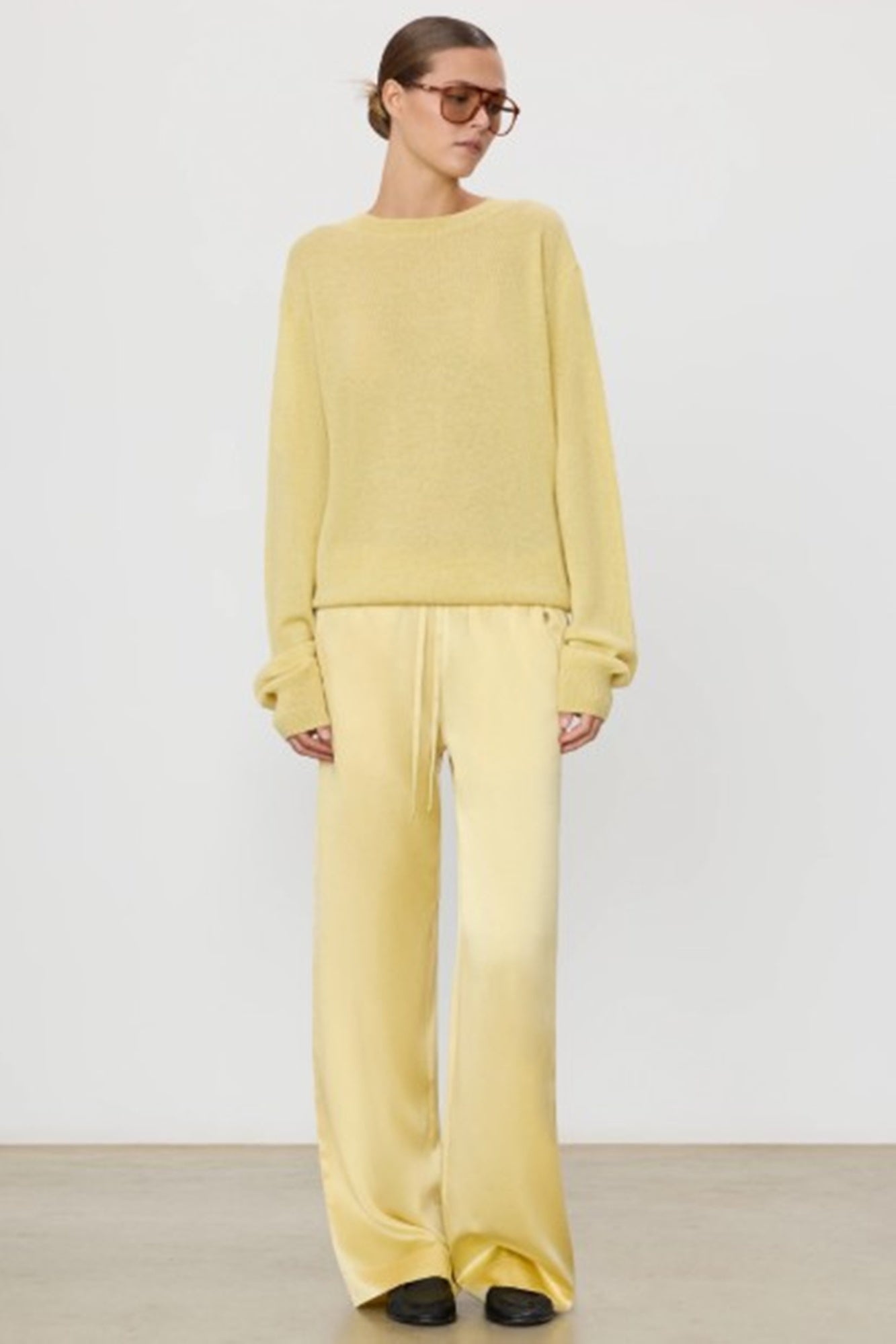 image of a model wearing the Eterne Brody Pants in Butter Yellow
