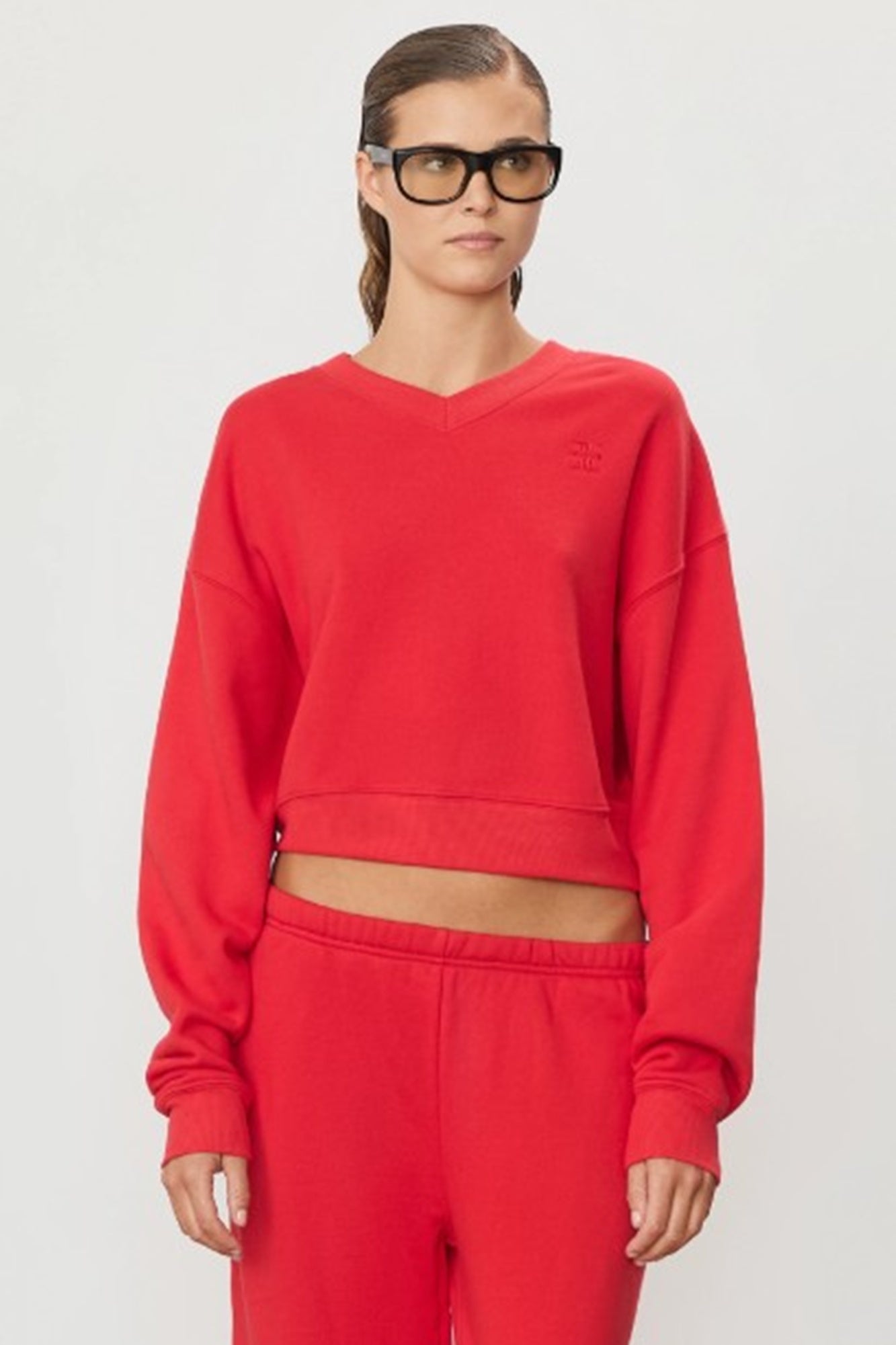 image of a model wearing the Eterne Cropped V Neck Sweatshirt in Rouge
