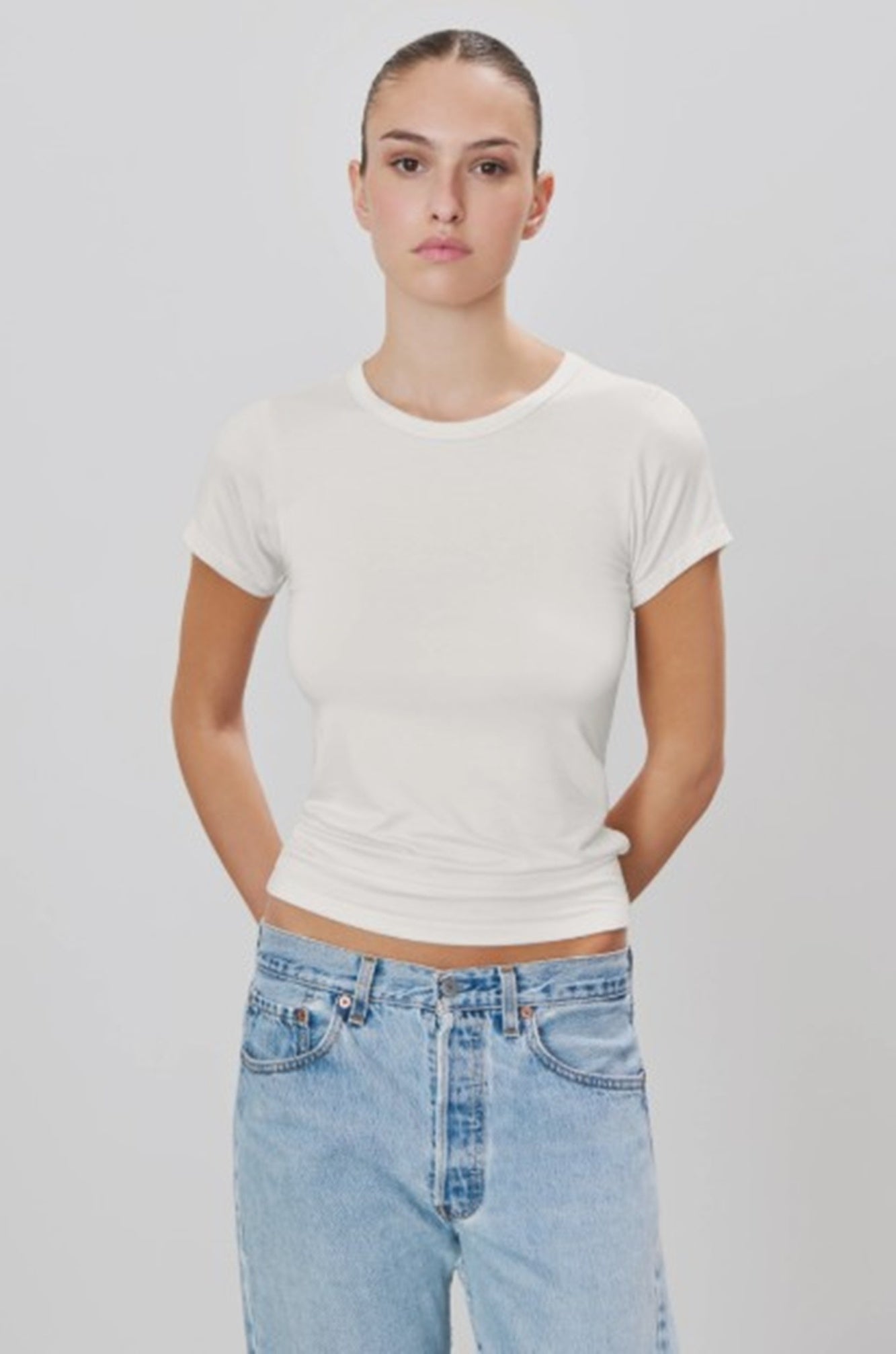 image of a woman wearing the Eterne fitted crewneck short sleeve shirt in ivory