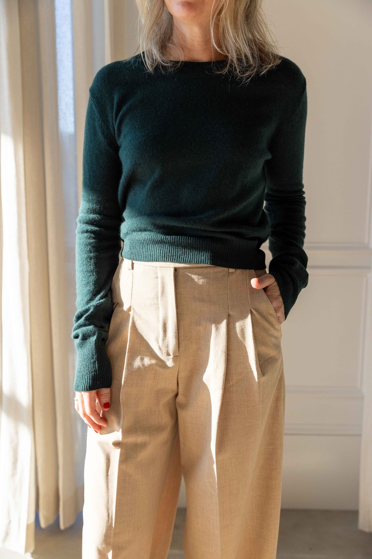 by Malene Birger Cymbaria Pants in sand with pressed front pleats, styled with a dark green Eterne sweater