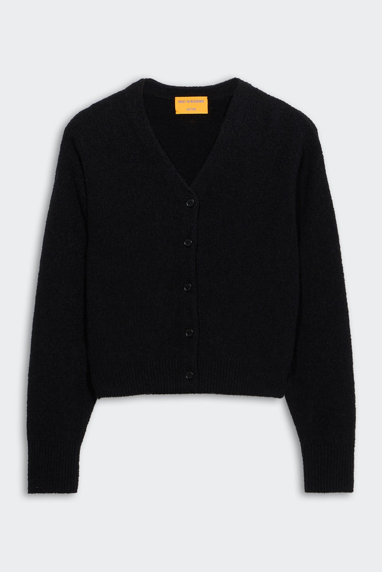 Black cardigan on a light gray background