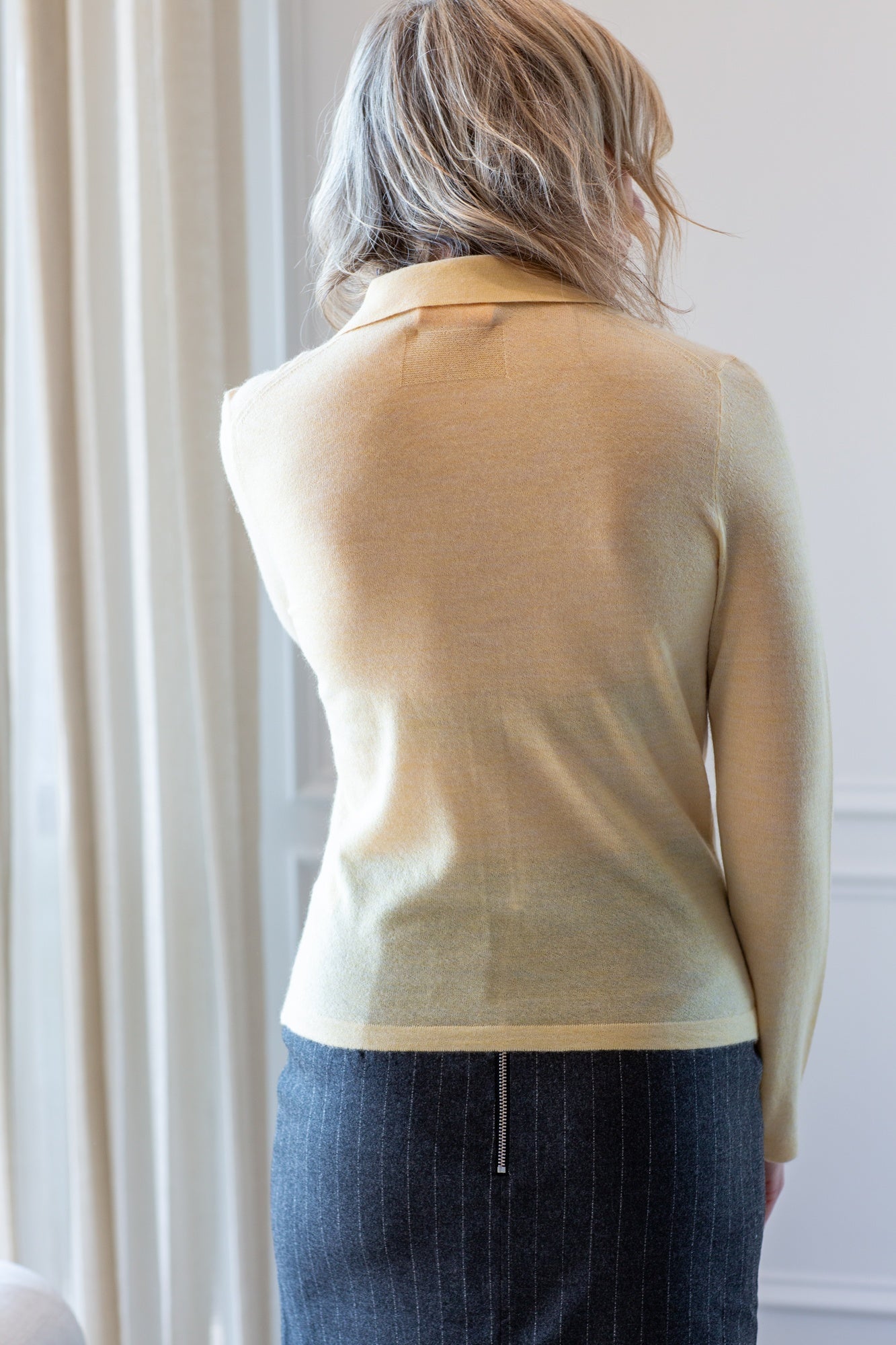 back image of a model wearing the guest in residence elle shirt and house of dagmar pinstripe skirt