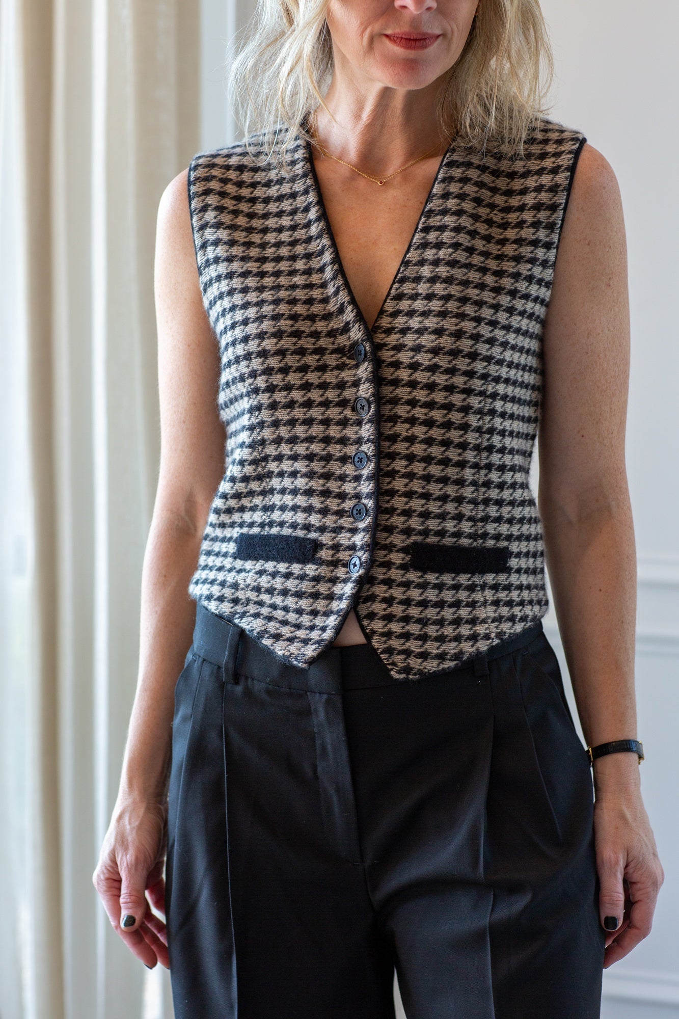 model wearing the guest in residence houndstooth vest and the Garment pluto pants