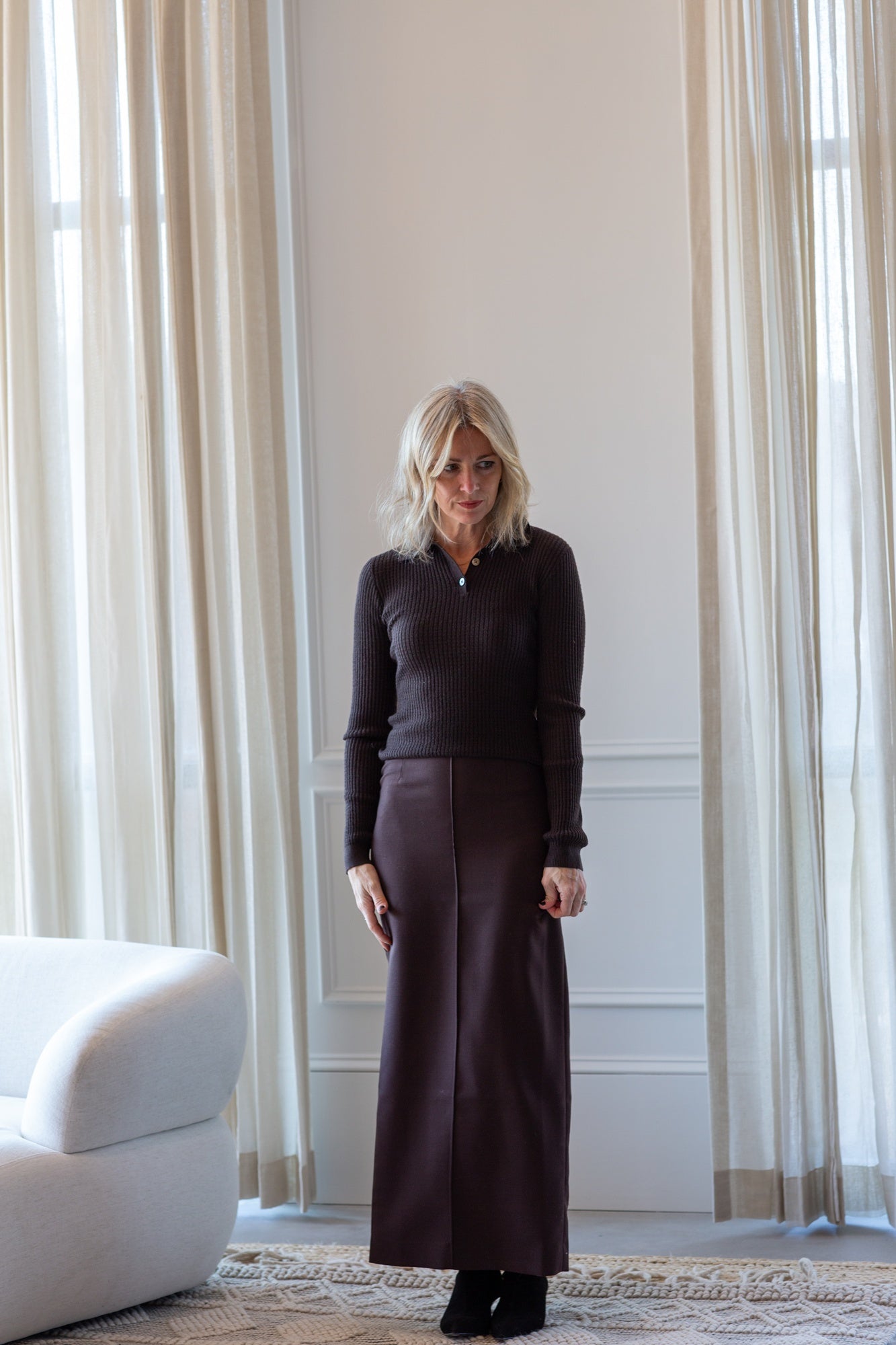 model wearing the guest in residence long sleeve polo and house of dagmar pencil skirt