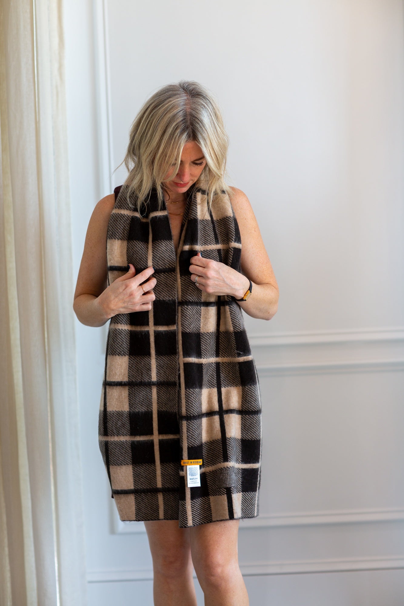 model wearing the guest in residence plaid scarf