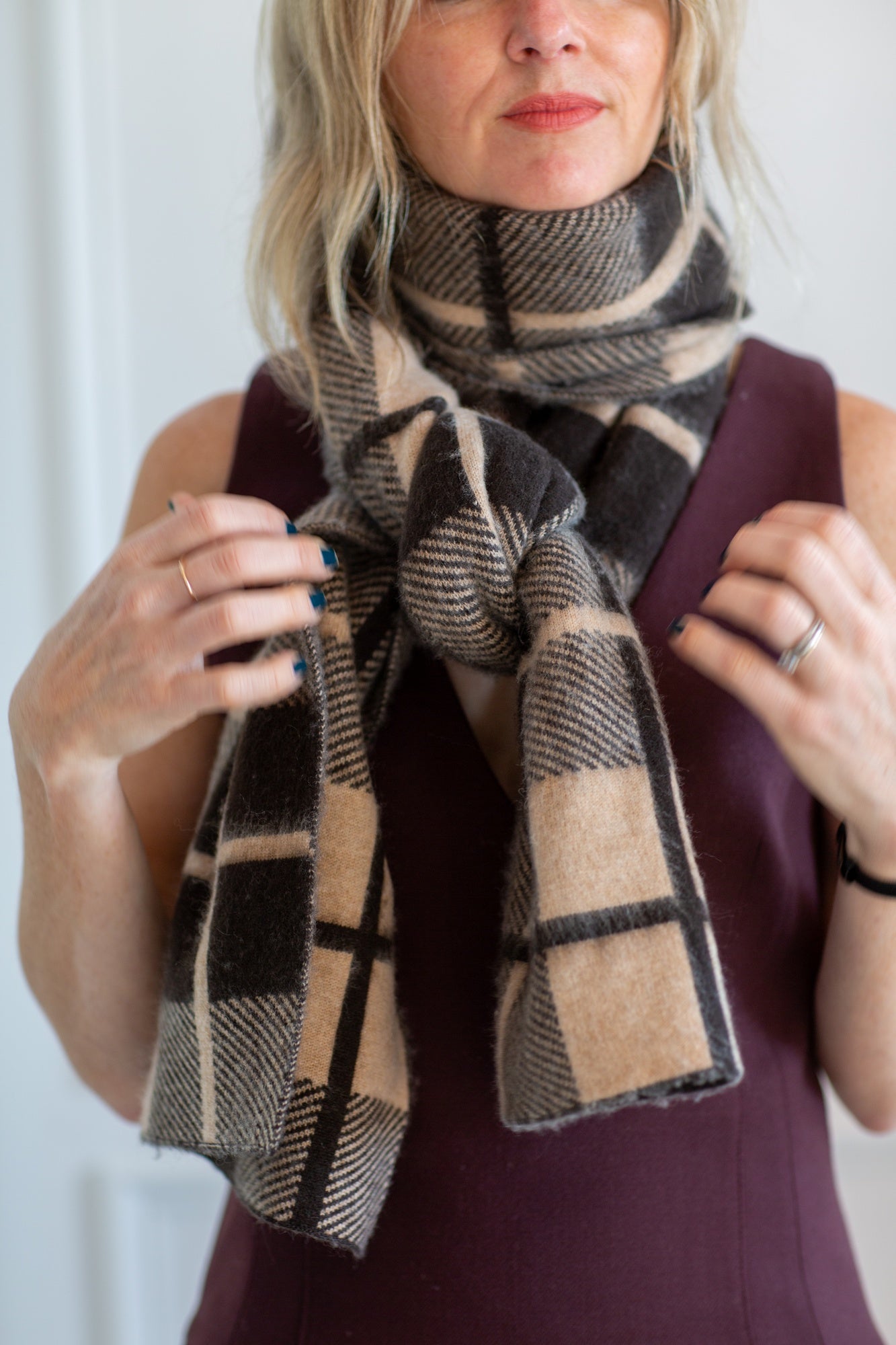 model wearing the guest in residence plaid scarf