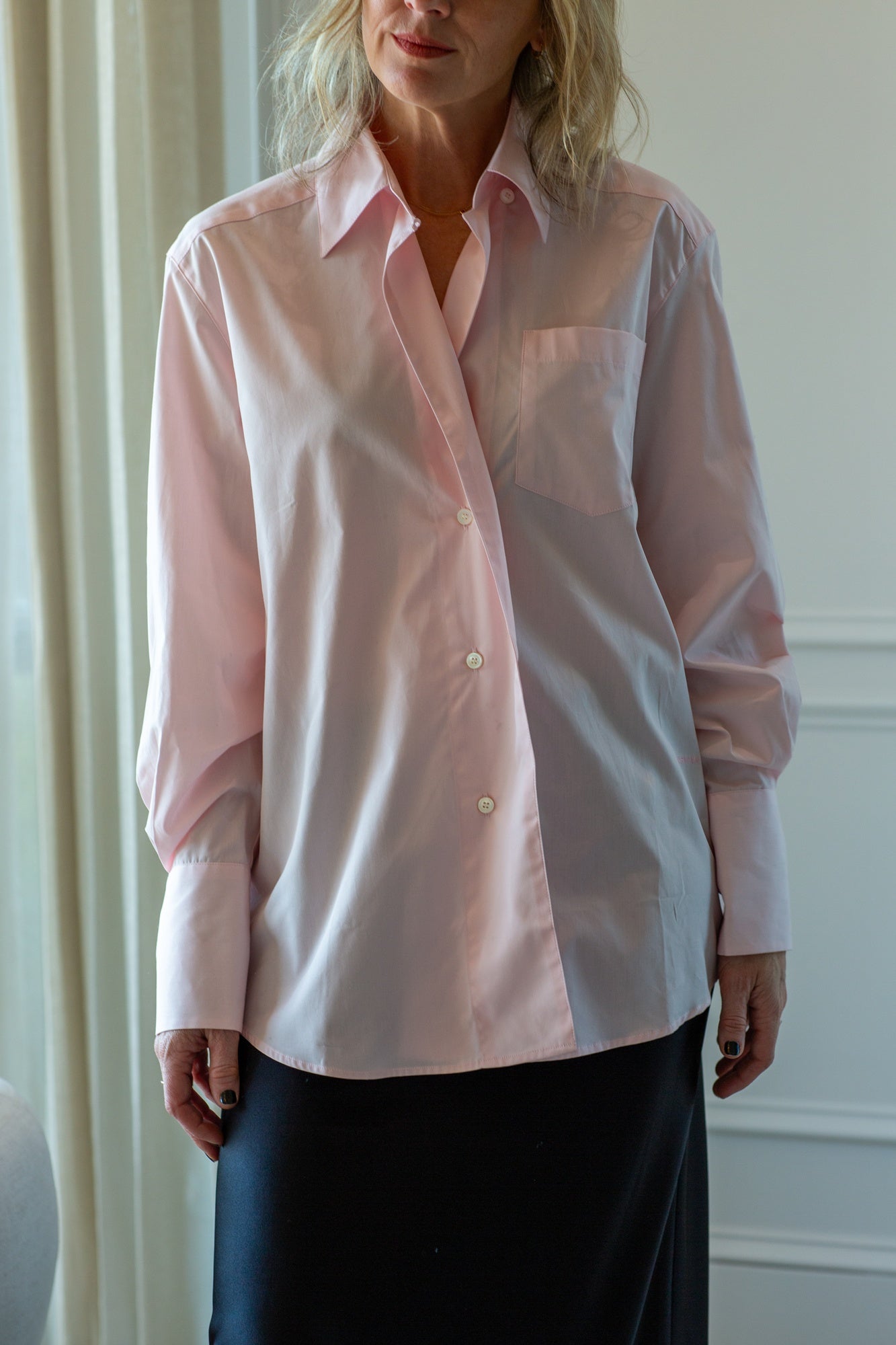 model wearing the house of dagmar asymmetrical shirt in pink