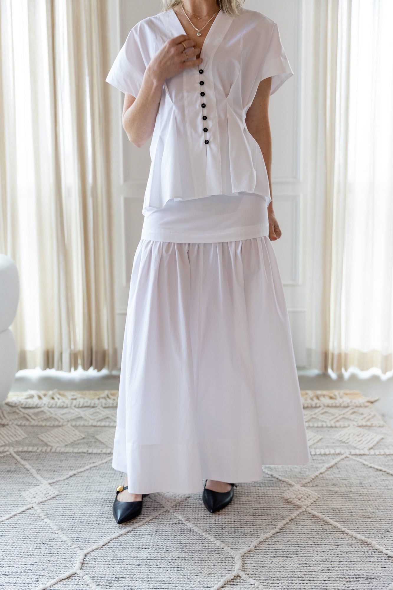 image of a woman wearing the House of Dagmar Cinched Cotton Top and Maxi Skirt