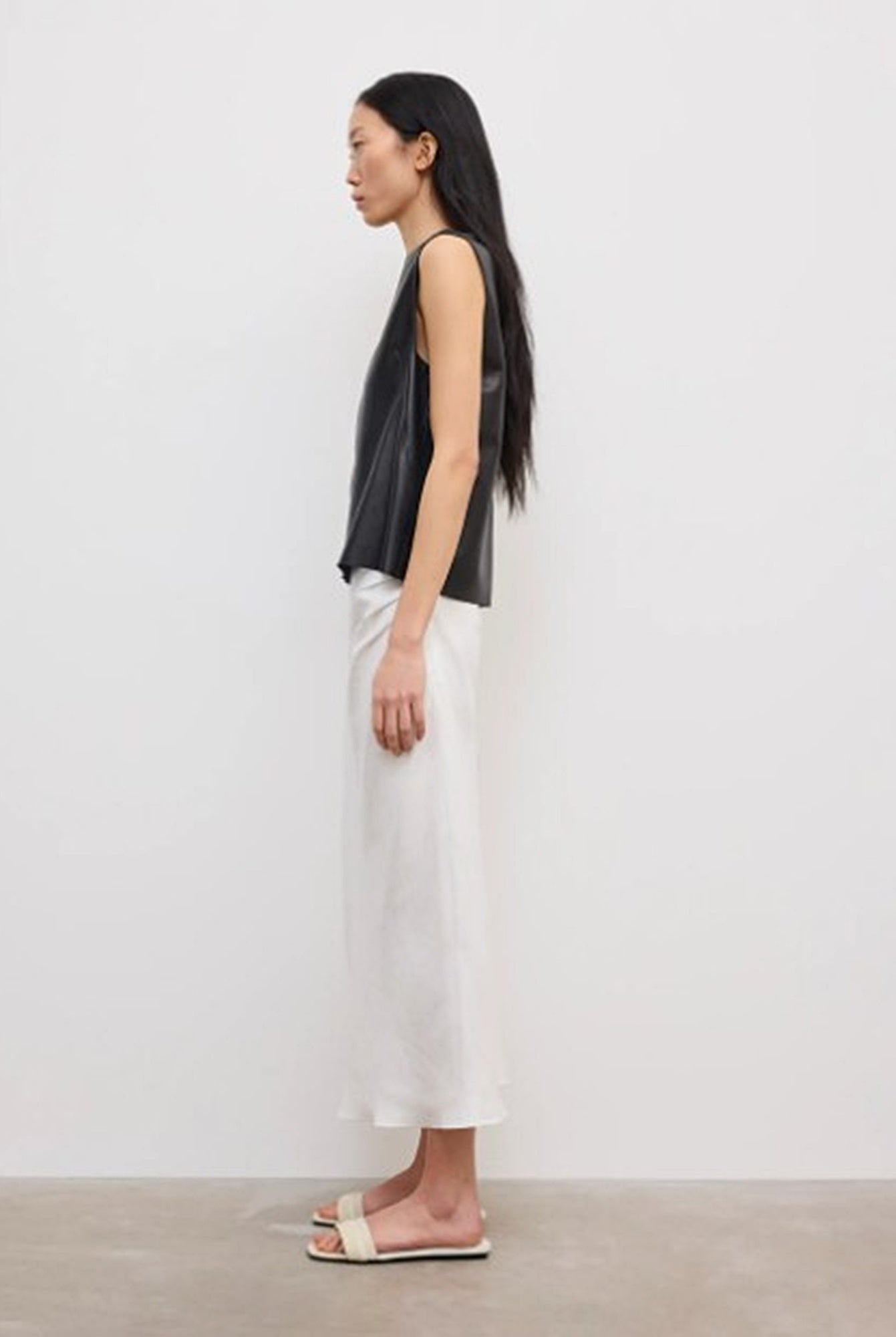 side image of a model wearing the House of Dagmar Draped Midi Skirt