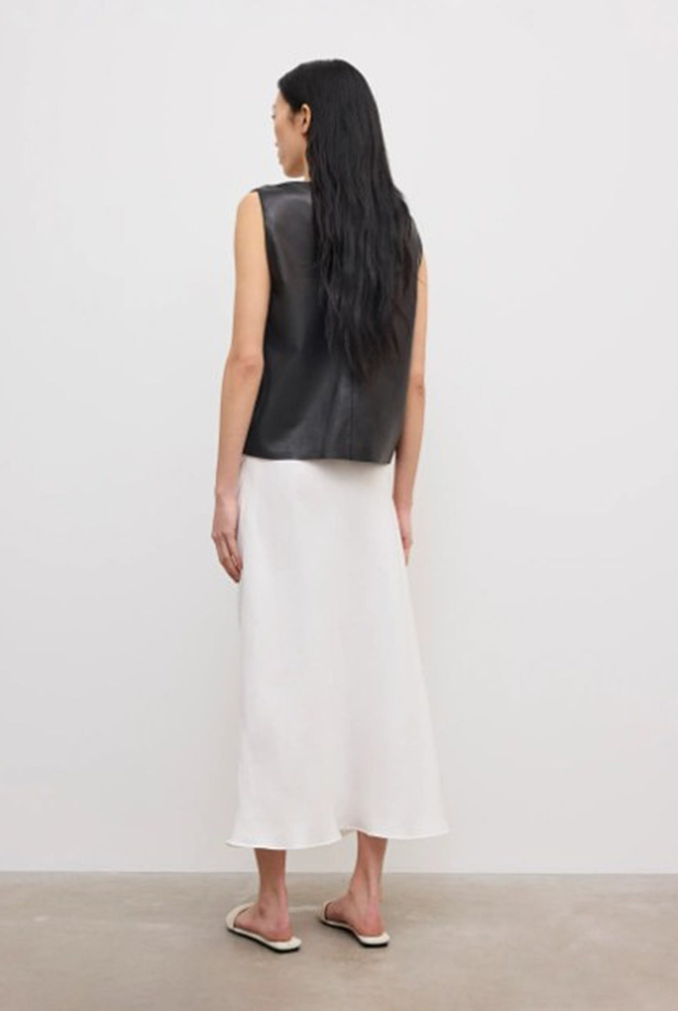 back image of a model wearing the House of Dagmar Draped Midi Skirt
