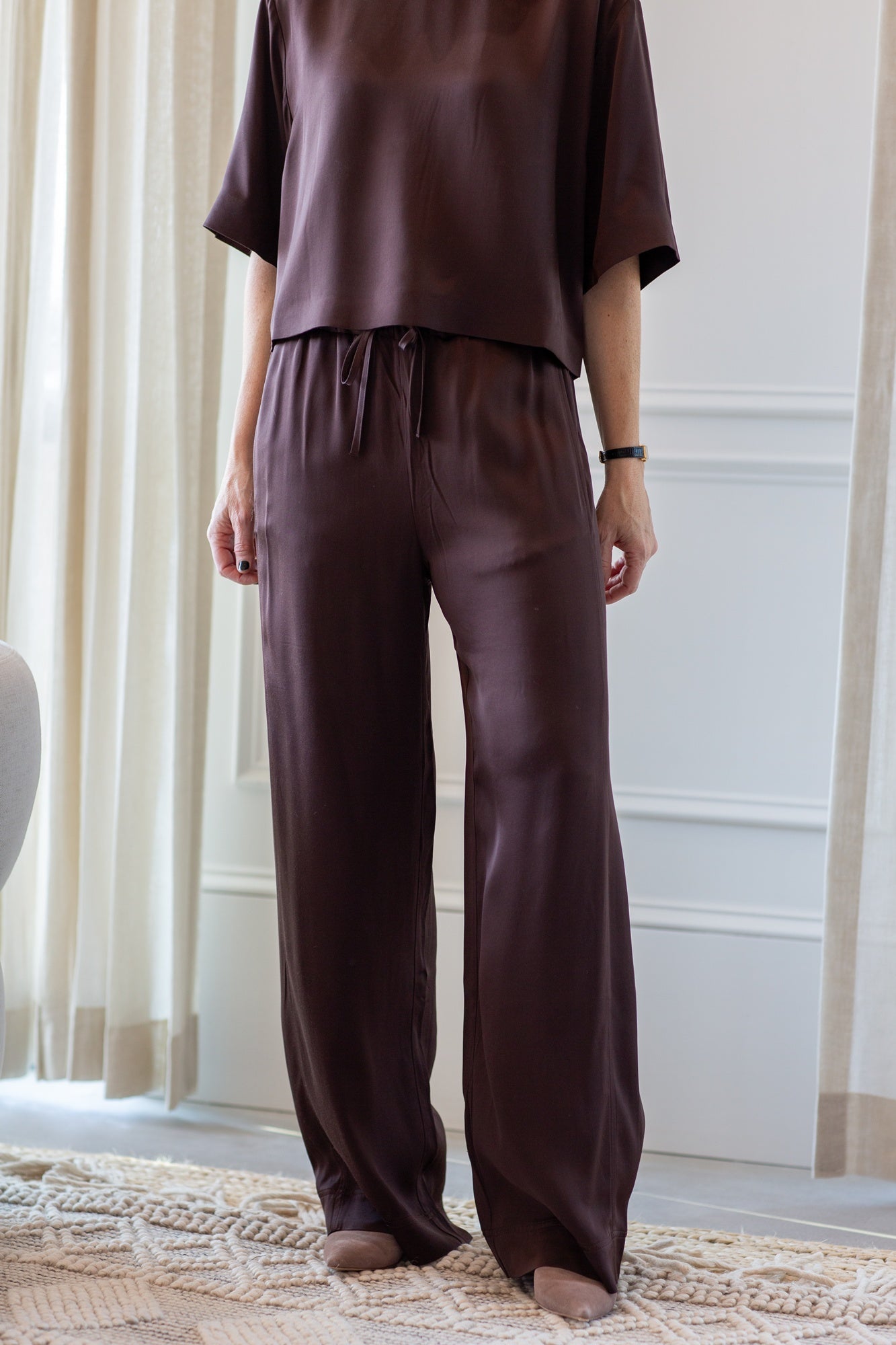 woman wearing the house of dagmar woven fluid shirt and drawstring trousers