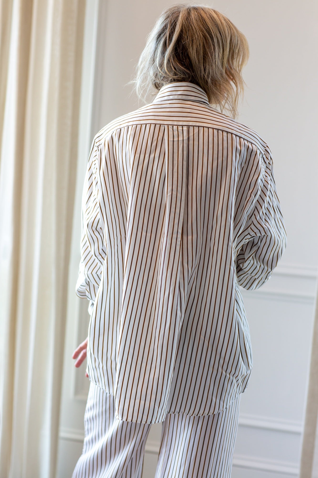 woman wearing the house of dagmar fluid stripe shirt