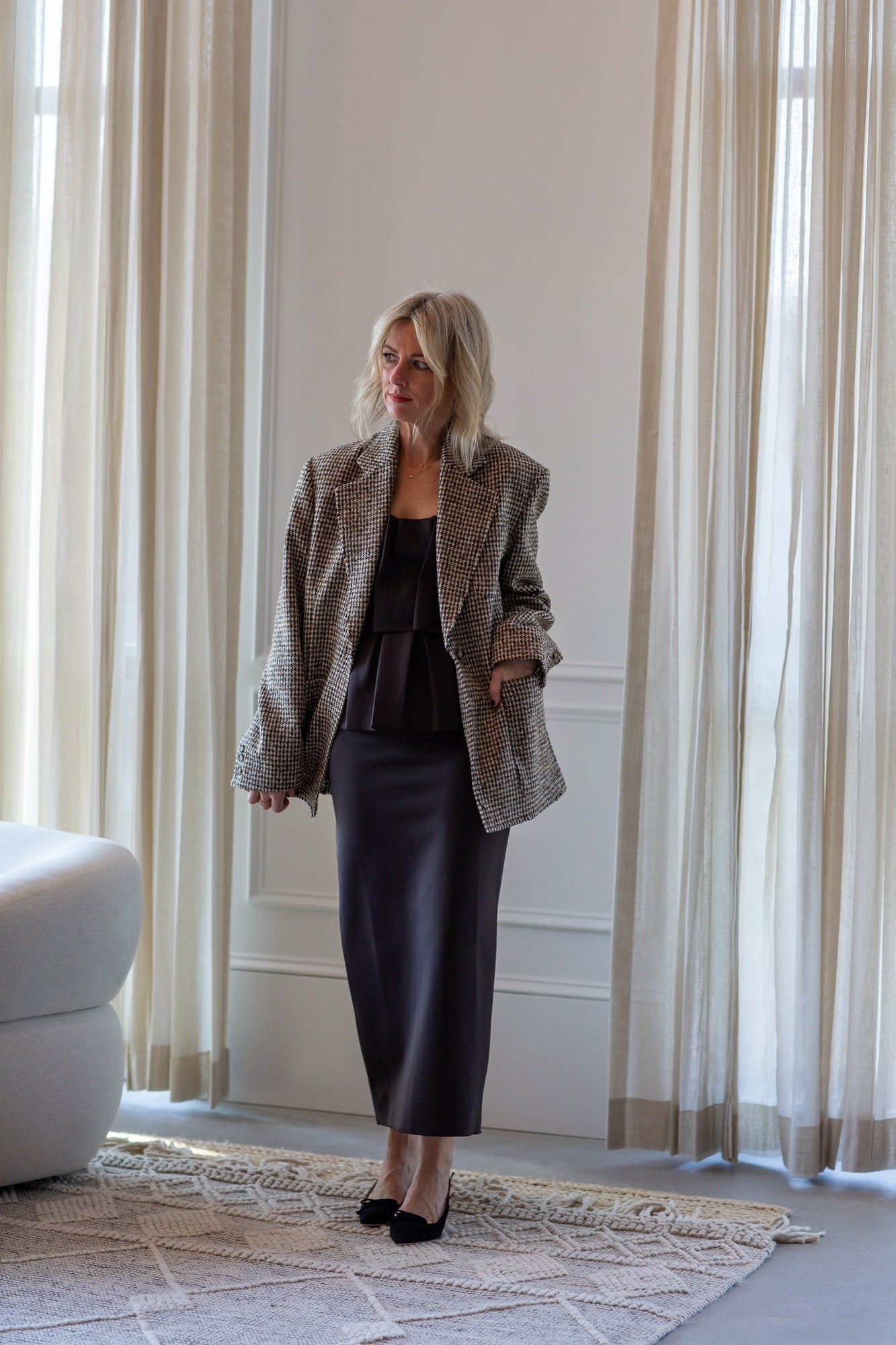 model wearing the house of dagmar houndstooth blazer and sculpted tube dress