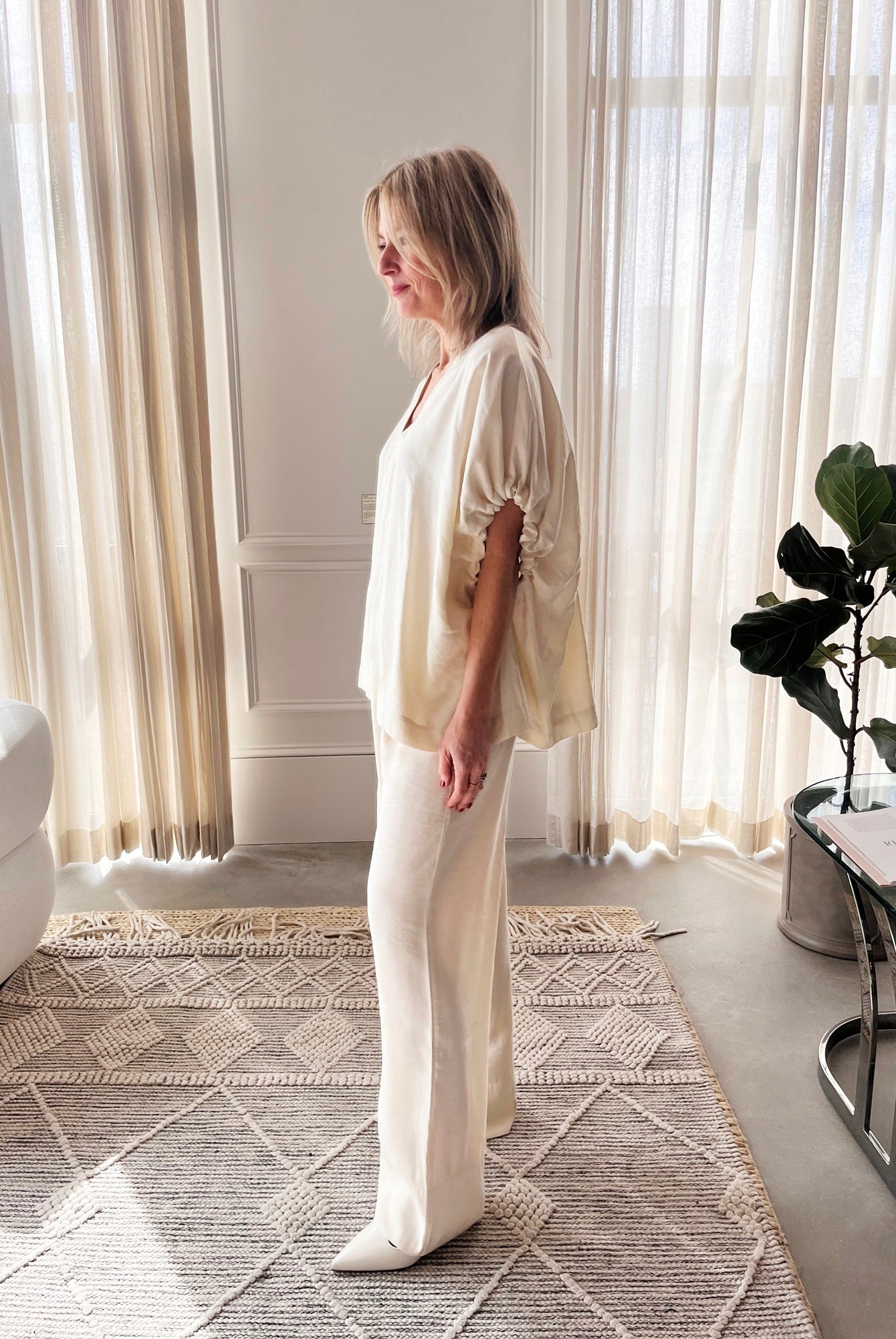 image of a woman wearing the House of Dagmar Rouched Short Sleeve Top and Drawstring Trousers in Ivory