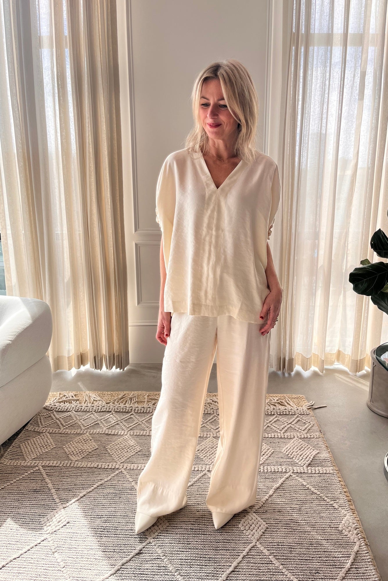 image of a woman wearing the House of Dagmar Rouched Short Sleeve Top and Drawstring Trousers in Ivory