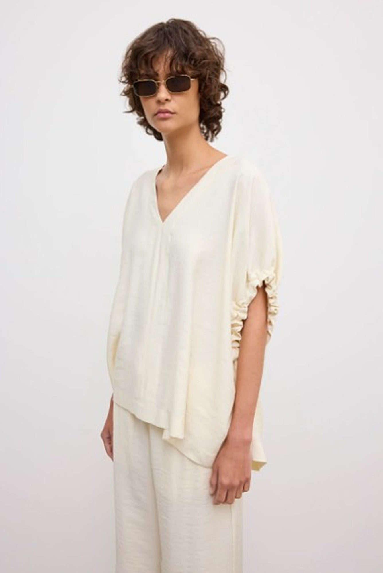 image of a woman wearing the House of Dagmar Rouched Short Sleeve Top and Drawstring Trousers in Ivory