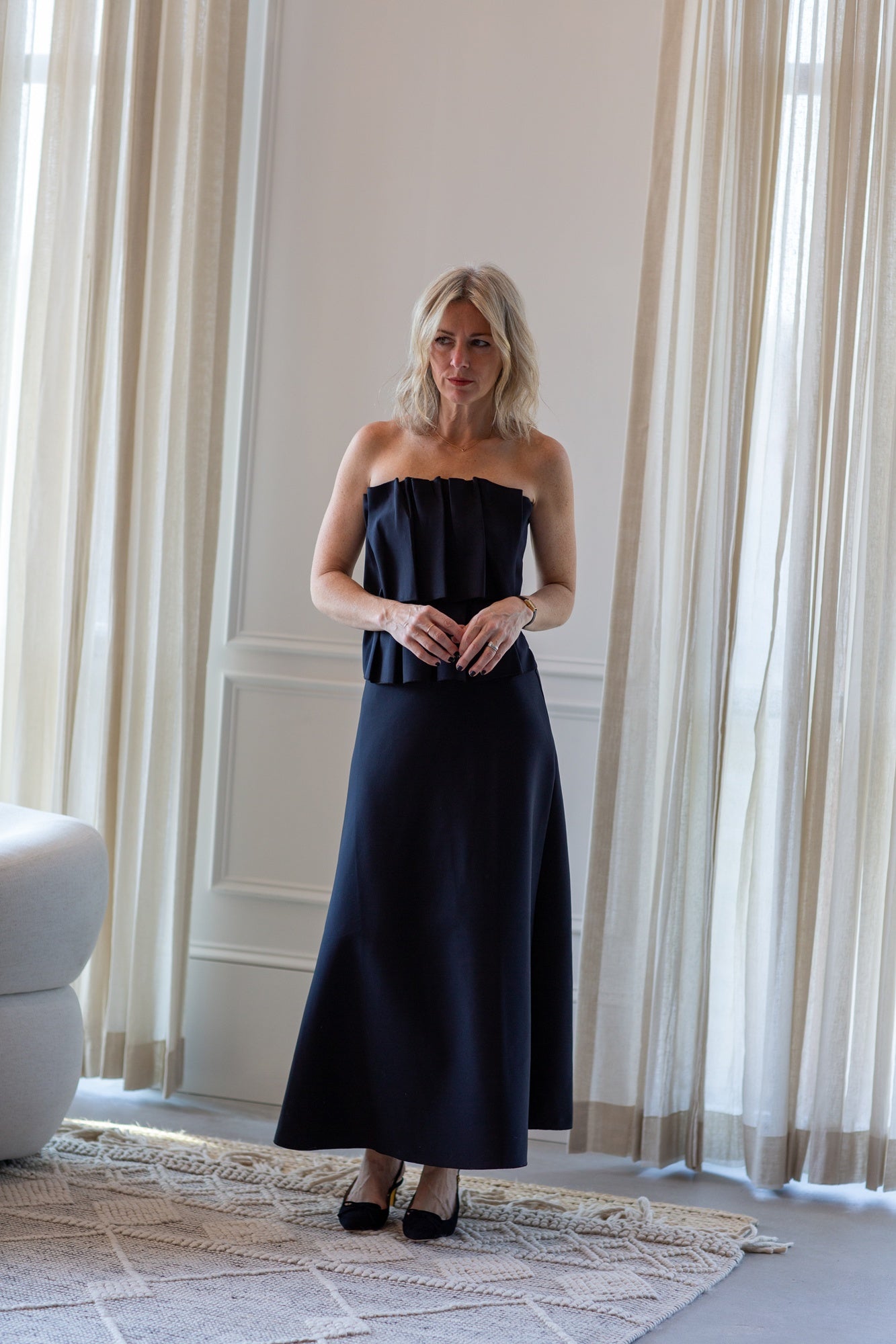 woman wearing the house of dagmar sculpted tube dress in black