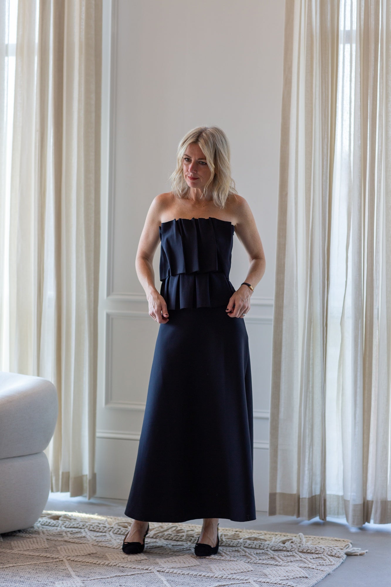 woman wearing the house of dagmar sculpted tube dress in black