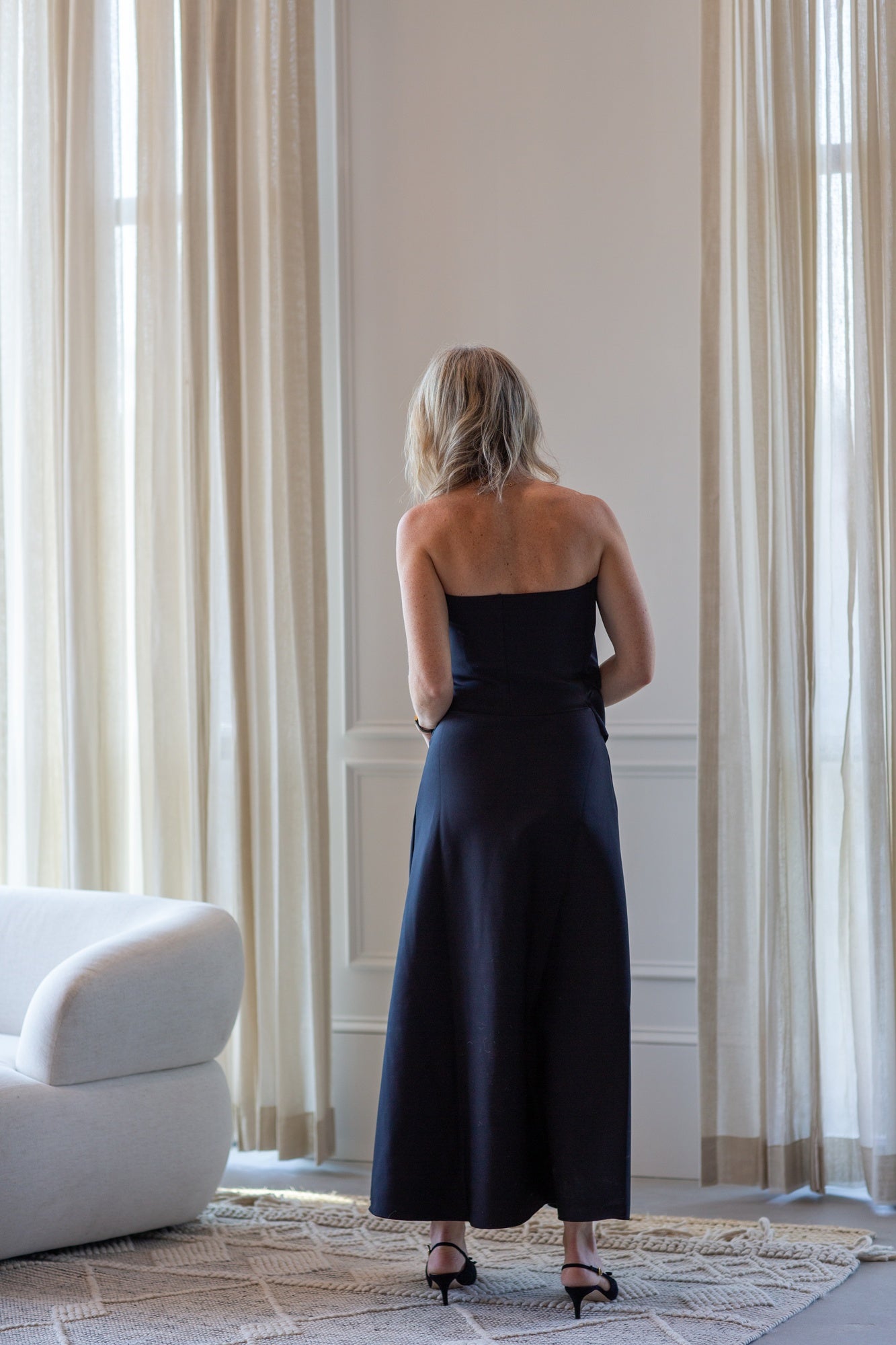 woman wearing the house of dagmar sculpted tube dress in black