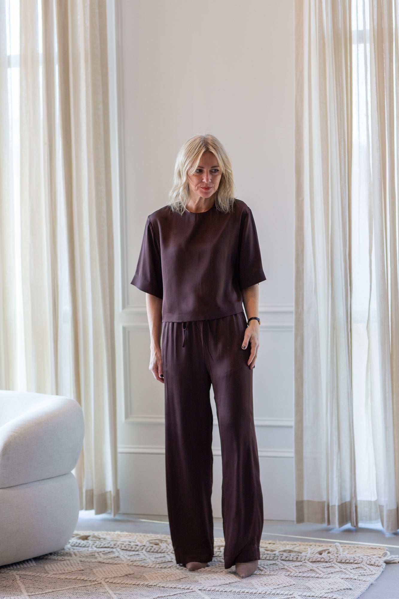 woman wearing the house of dagmar woven fluid shirt and drawstring trousers