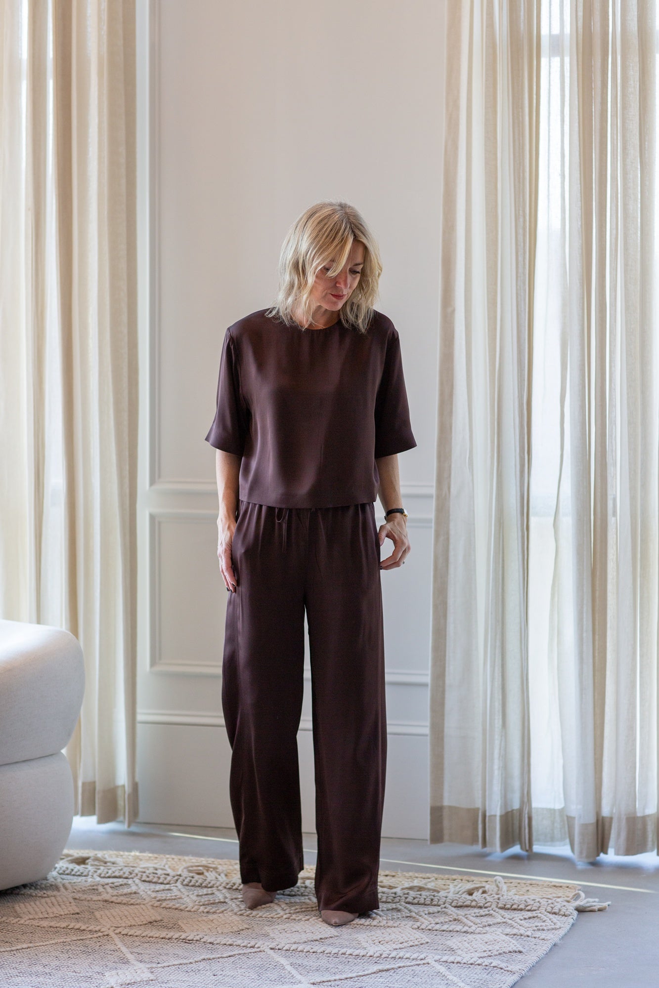 woman wearing the house of dagmar woven fluid shirt and drawstring trousers