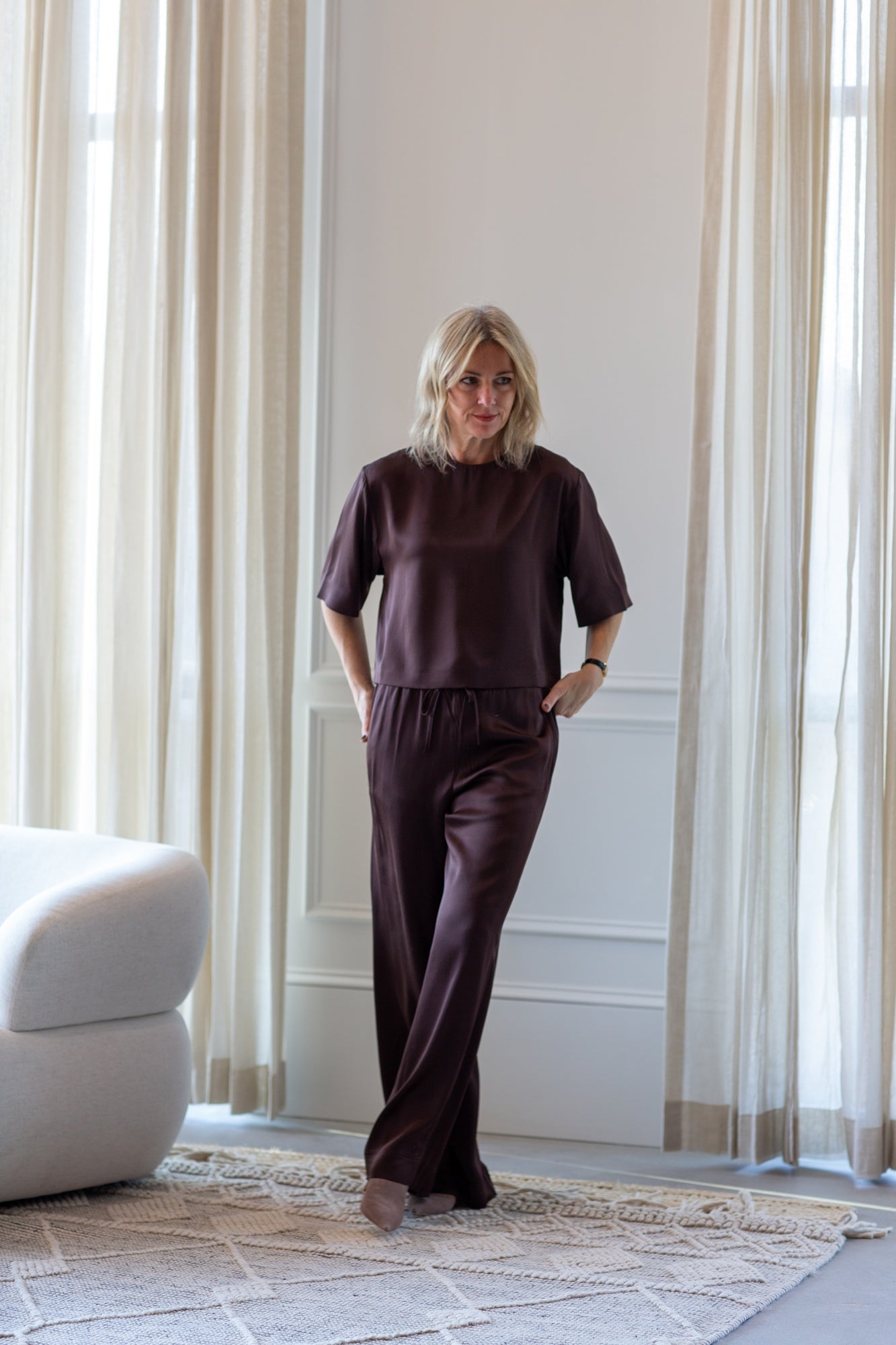 woman wearing the house of dagmar woven fluid shirt and drawstring trousers