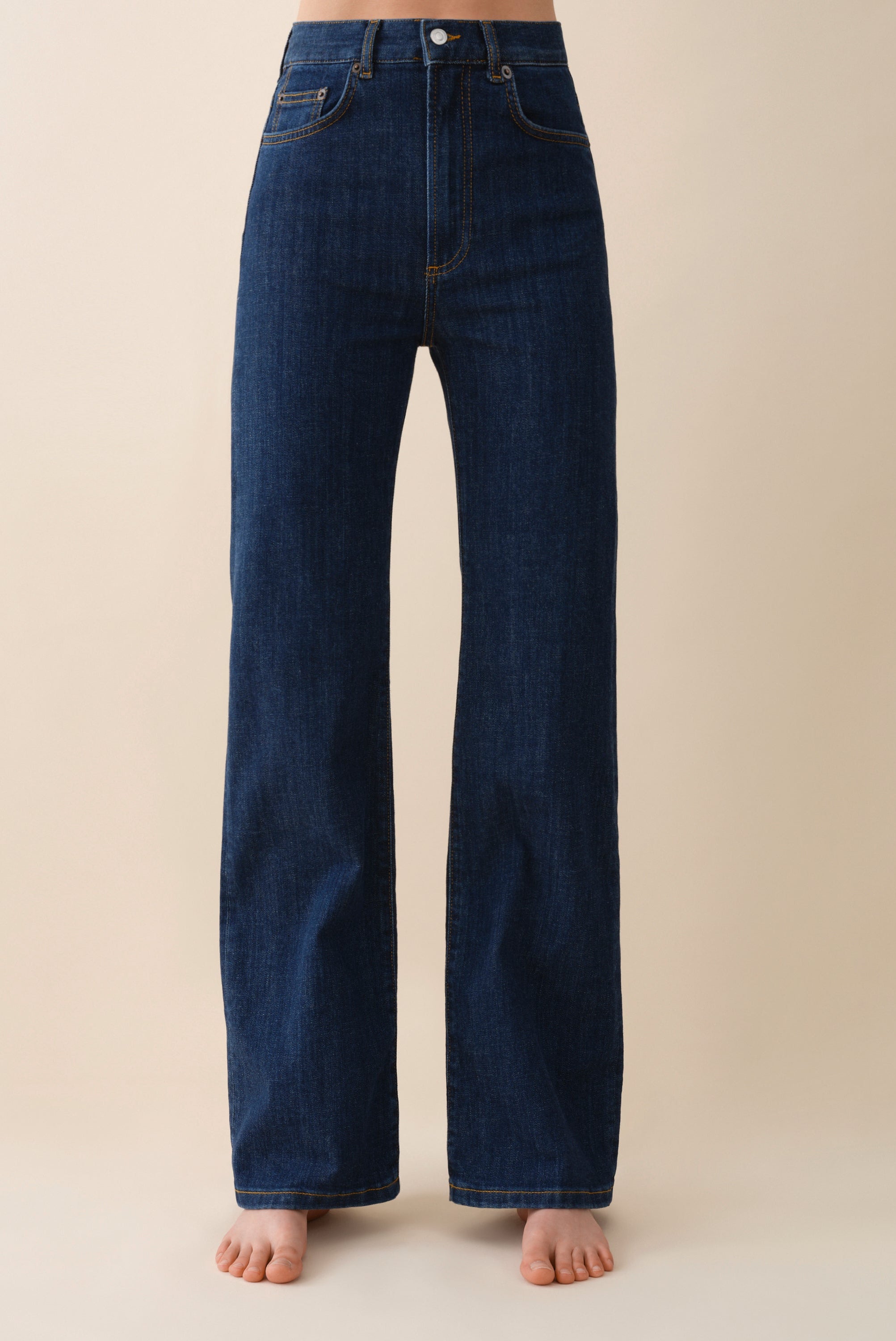 Dark blue jeans on a beige background