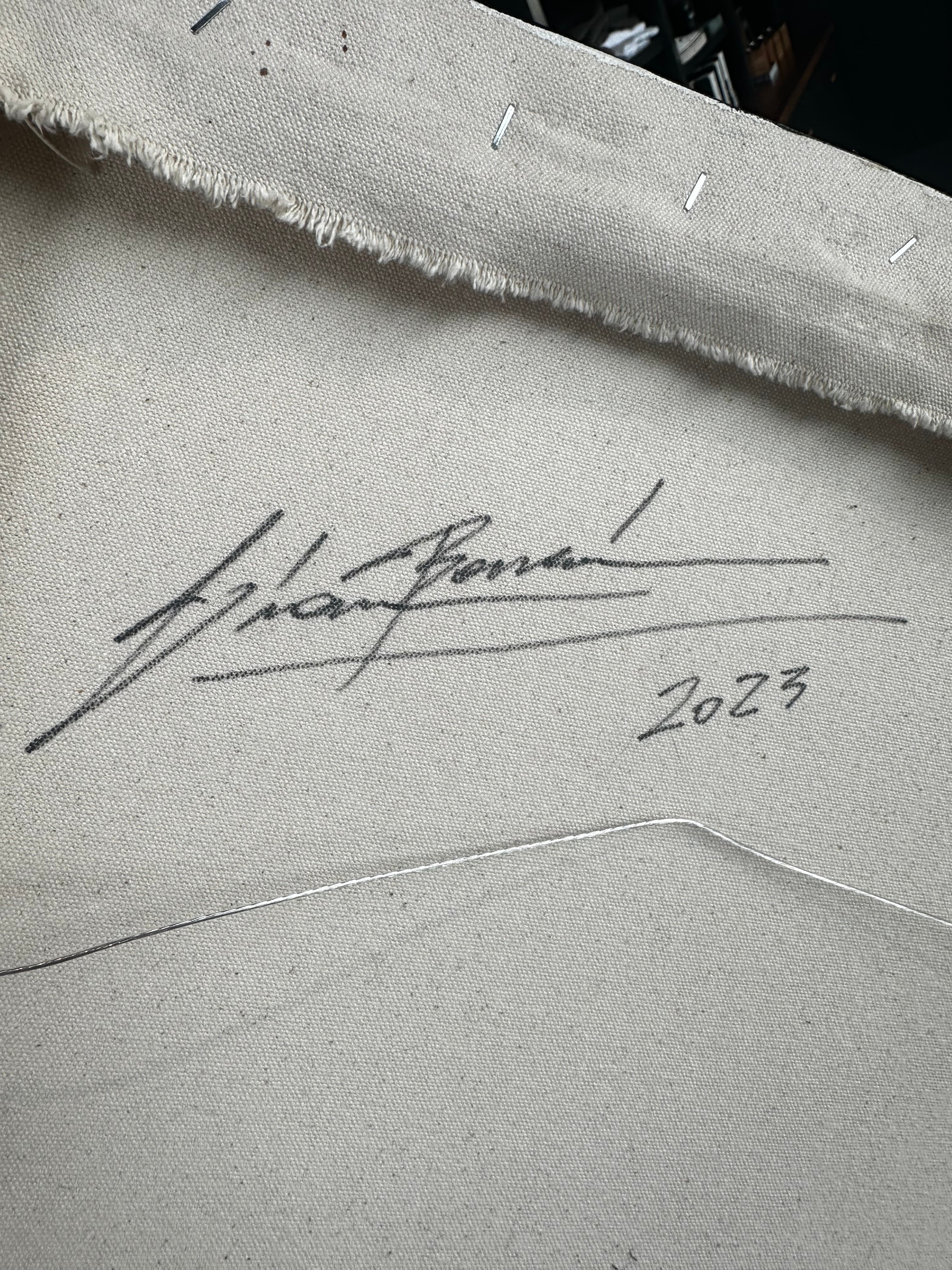 Signature and date on a textured surface