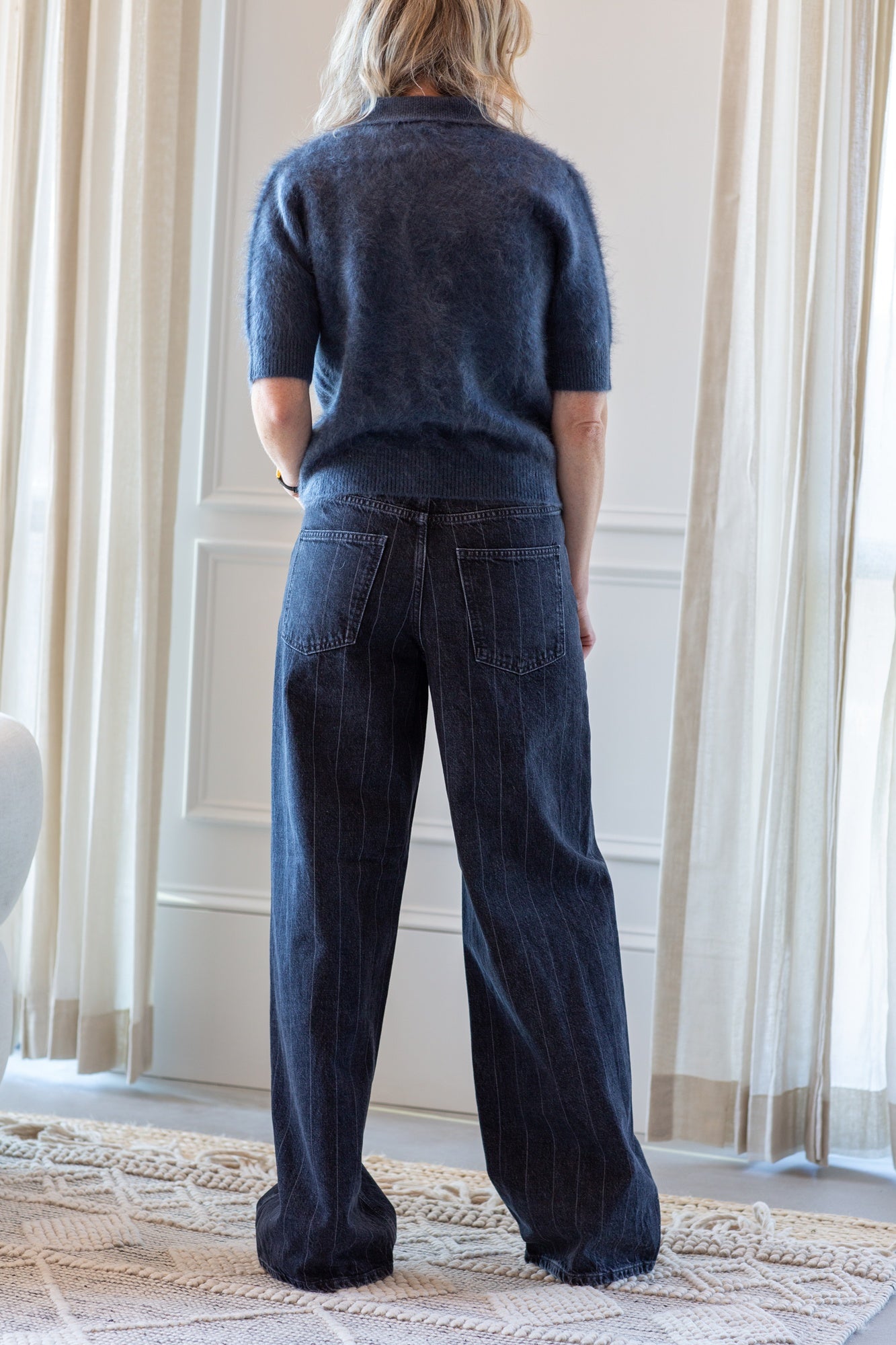 model wearing the lisa yang carolyn brushed cashmere sweater and house of dagmar baggy cut jeans
