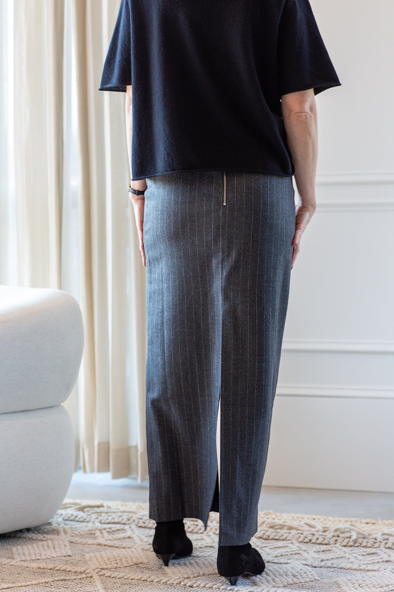 model wearing the lisa yang cila sweater and house of dagmar pinstripe pencil skirt