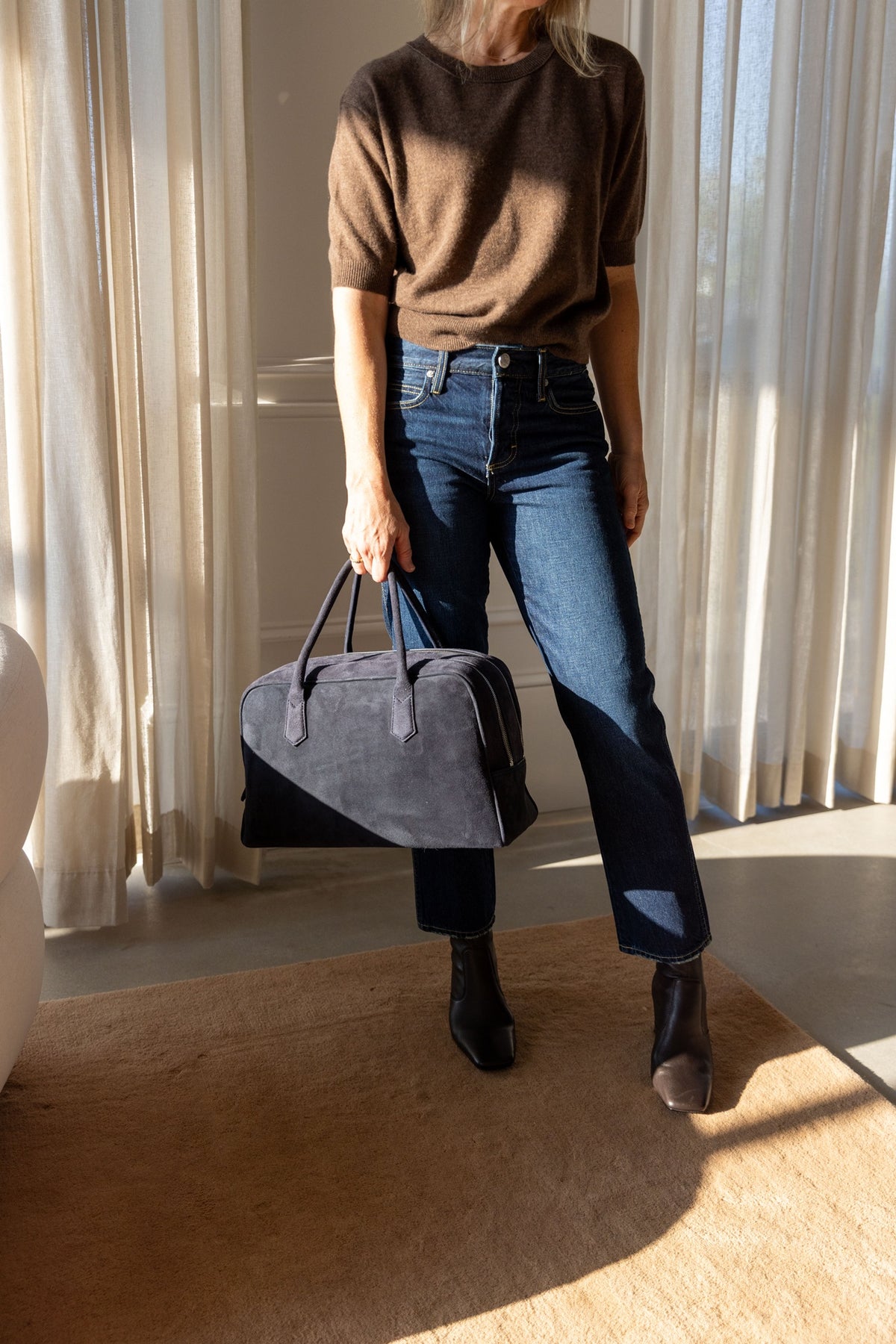 Lisa Yang Genevra T-Shirt in dark truffle with AMO jeans, carrying the A. Emery Talbot bag