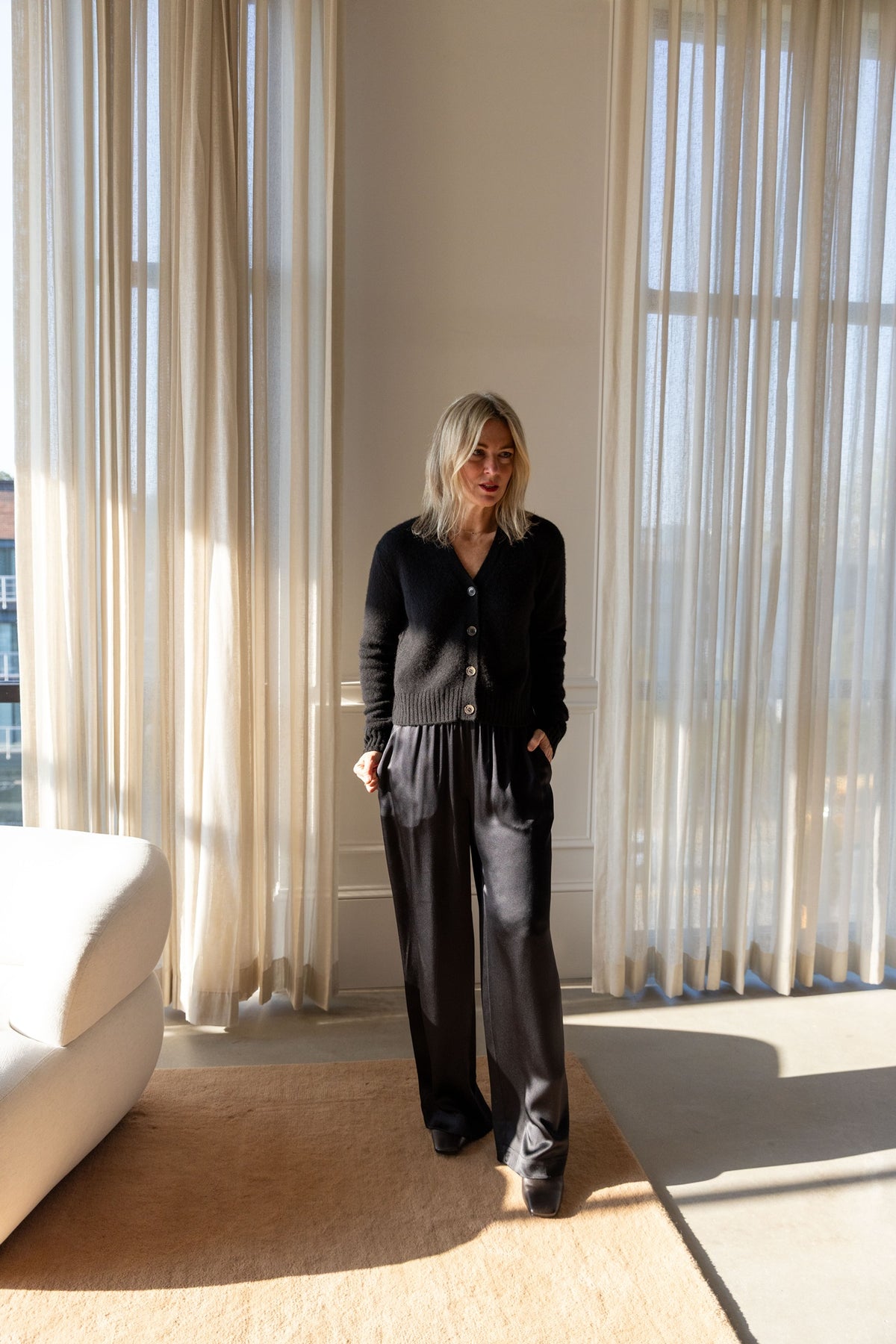 Lisa Yang Marionette Cardigan in black silk cashmere with Sablyn Brynn silk pants, full-length front view