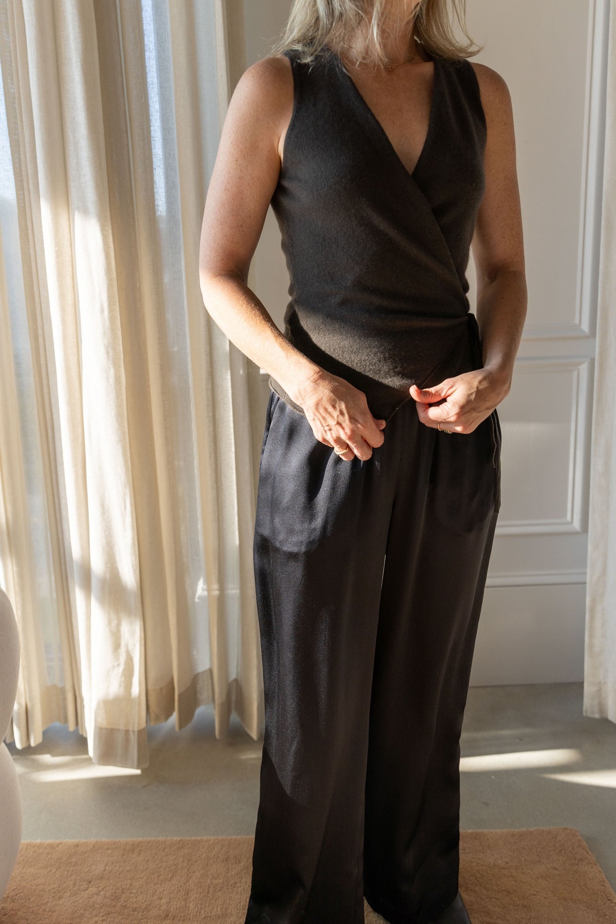 Lisa Yang Nayi Top in dark fern, tailored wrap front, worn with wide-leg Sablyn Brynn silk pants