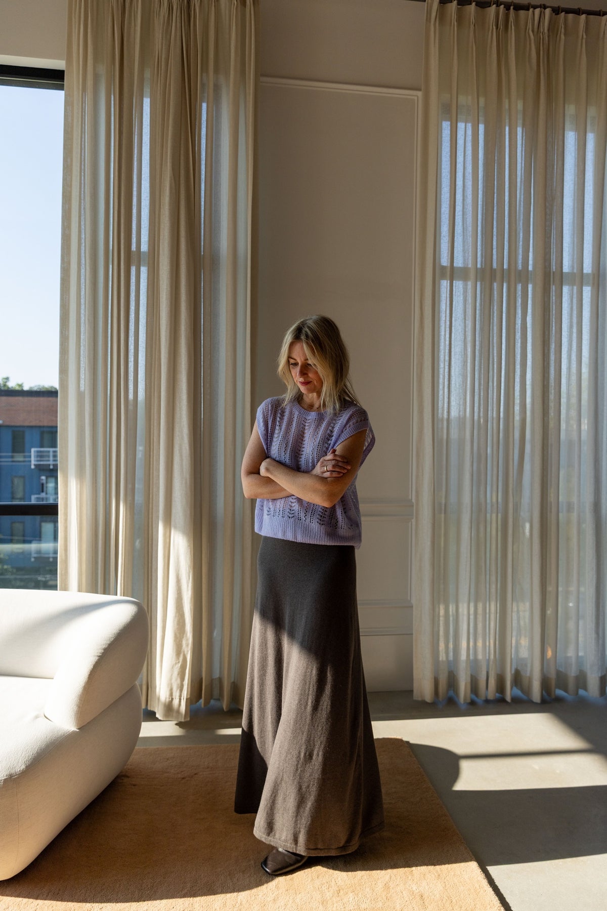 Lisa Yang Nian Vest in soft lavender with the deep walnut Adrienne skirt, full-length view in a sunlit room