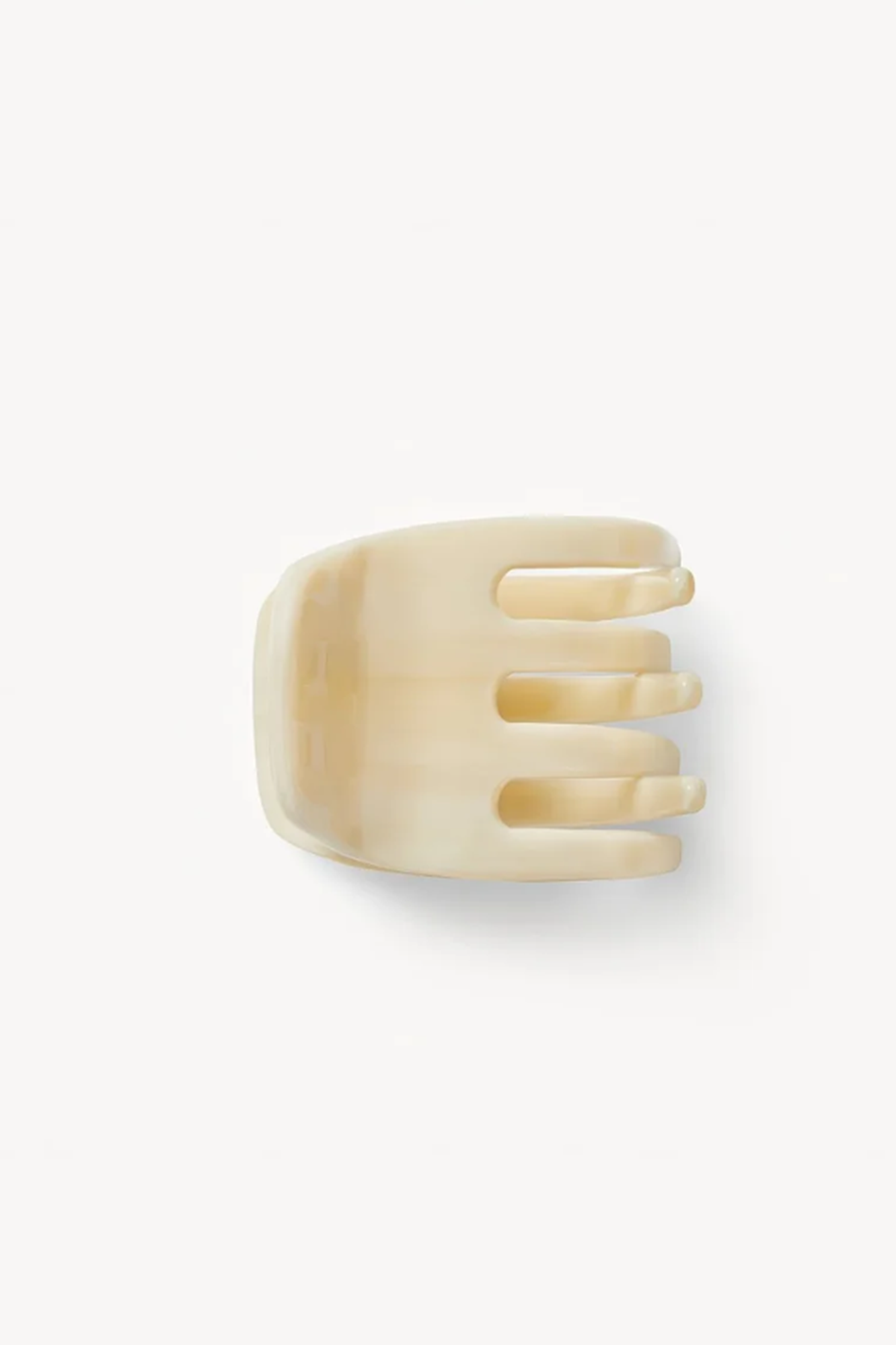 side view of an alabaster hair clip or claw on a white background