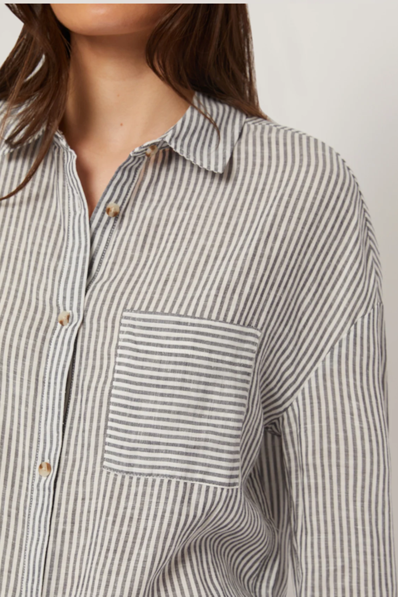 Striped shirt worn by a person on a plain background