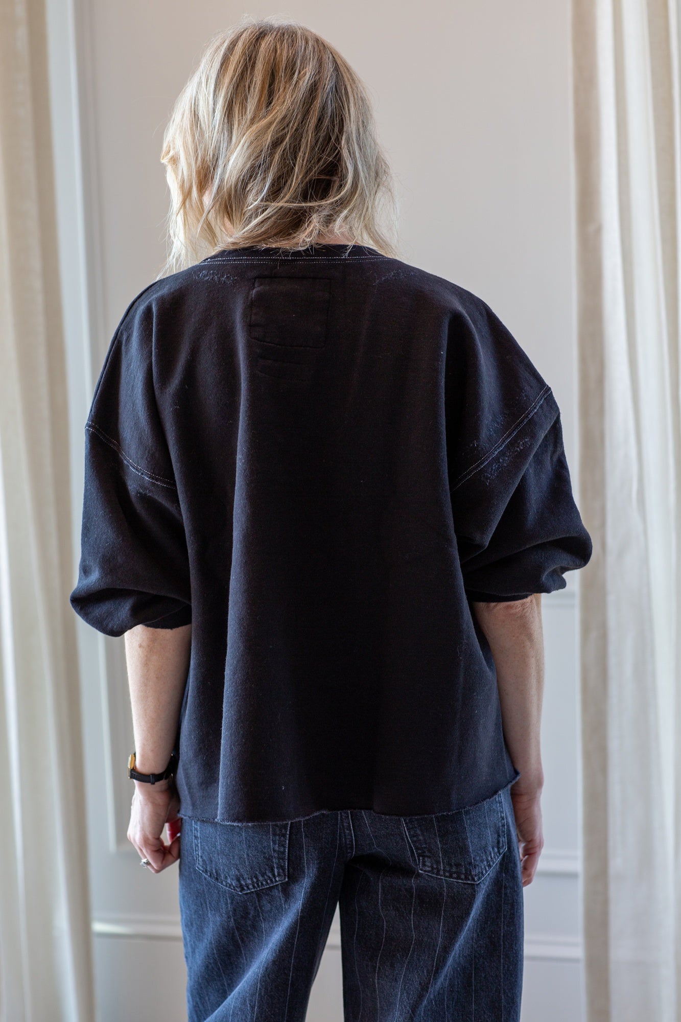 woman wearing the rachel comey fond sweatshirt in charcoal