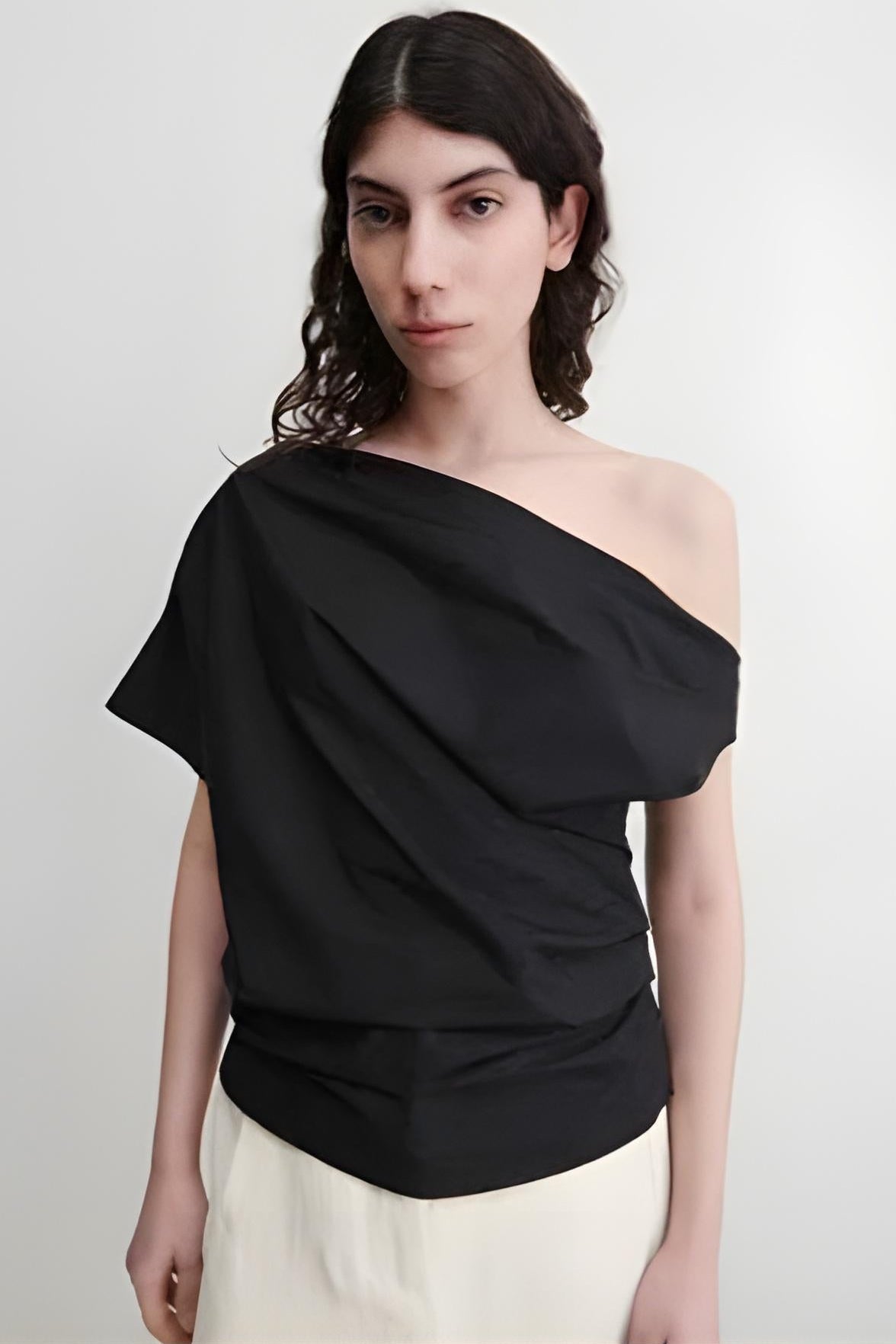 Model wearing Rachel Comey Mata Top in black standing against a white background