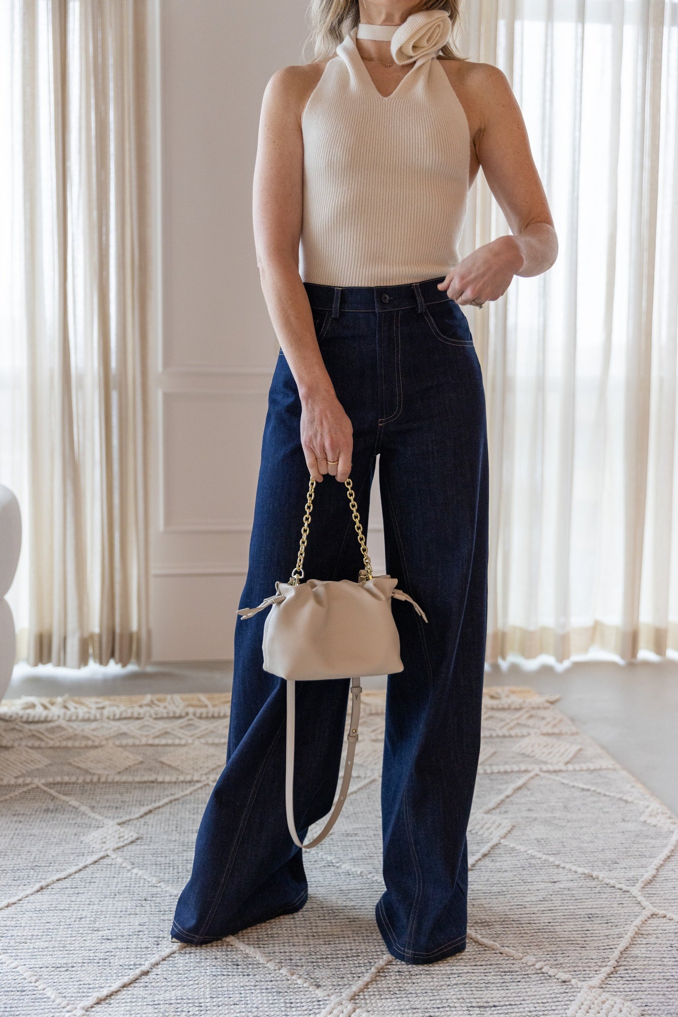 image of a woman wearing the Rhune Estelle Knit Top and Feline Denim
