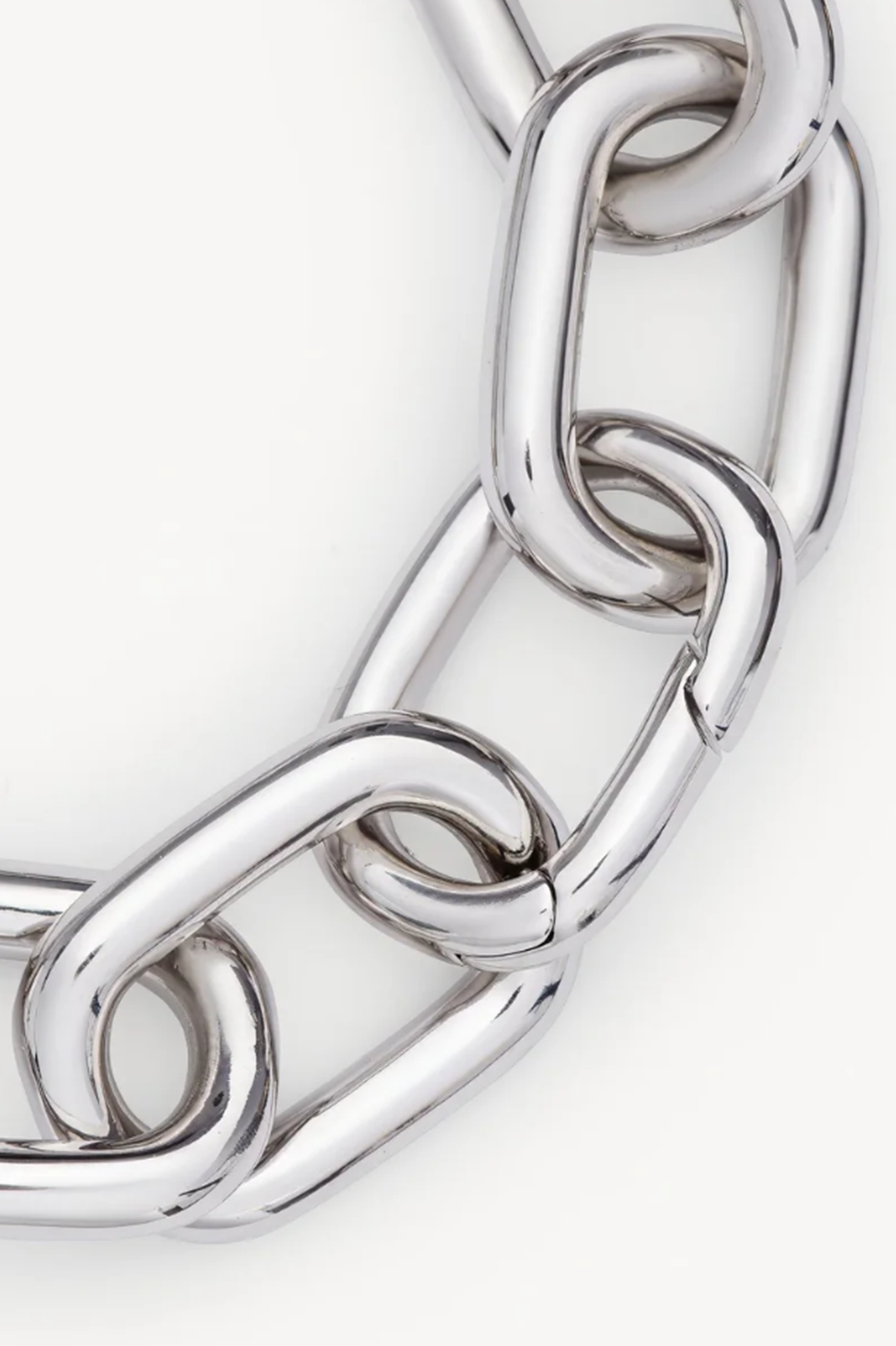 Close-up of a silver chain bracelet on a white background