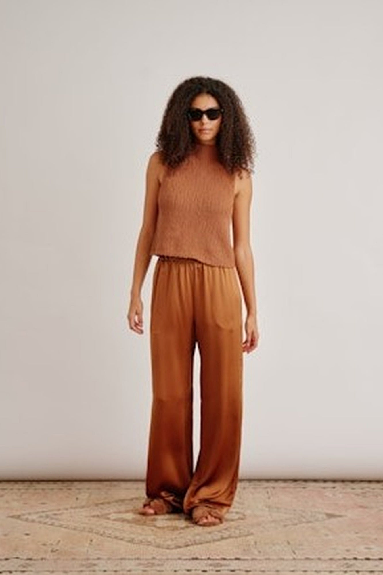image of a woman wearing the Sablyn Atticus Roll Top in Brynn Pants in Tobacco