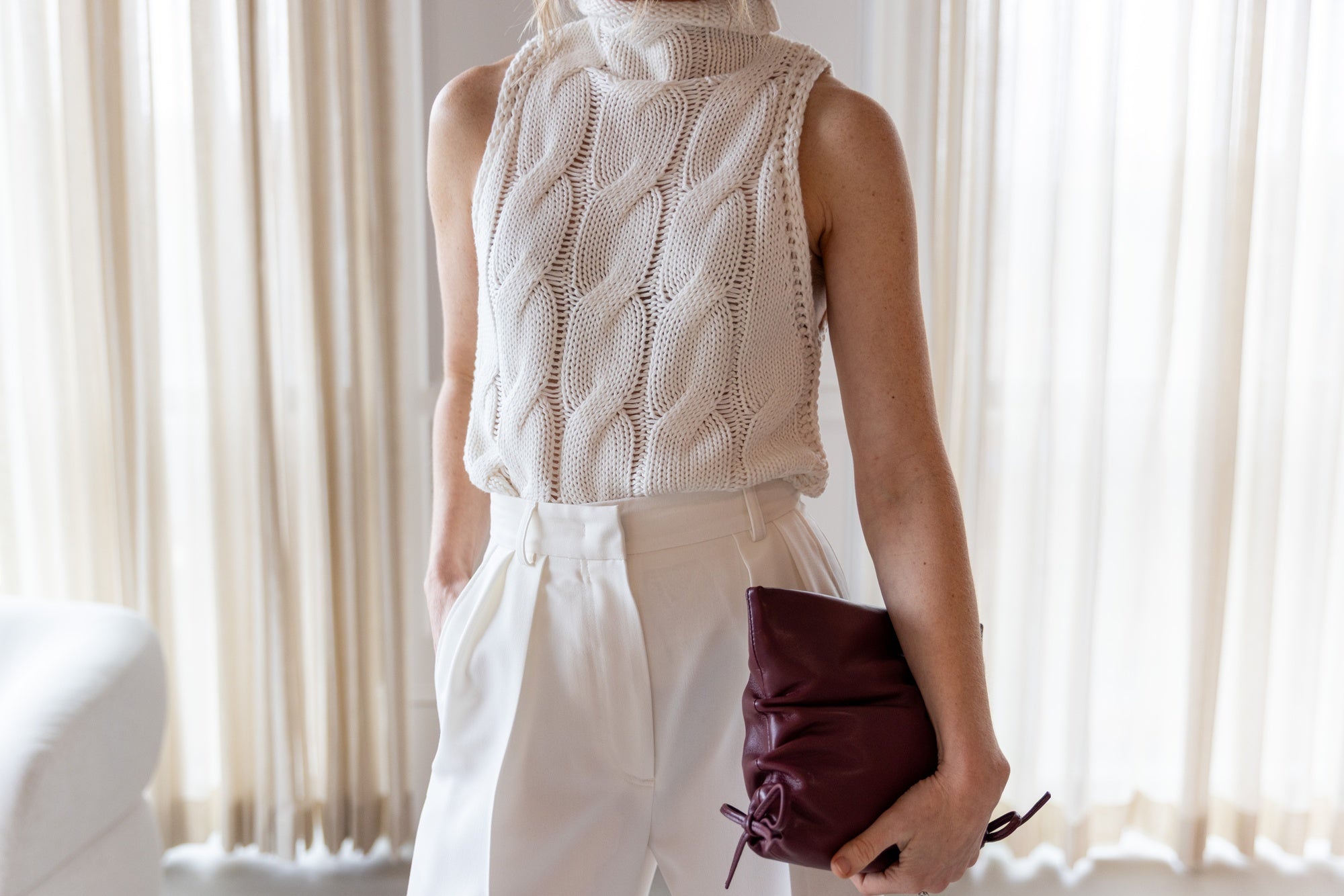 image of a woman wearing the Sablyn Salvia Knit Top and Rhune Celine Pants in White