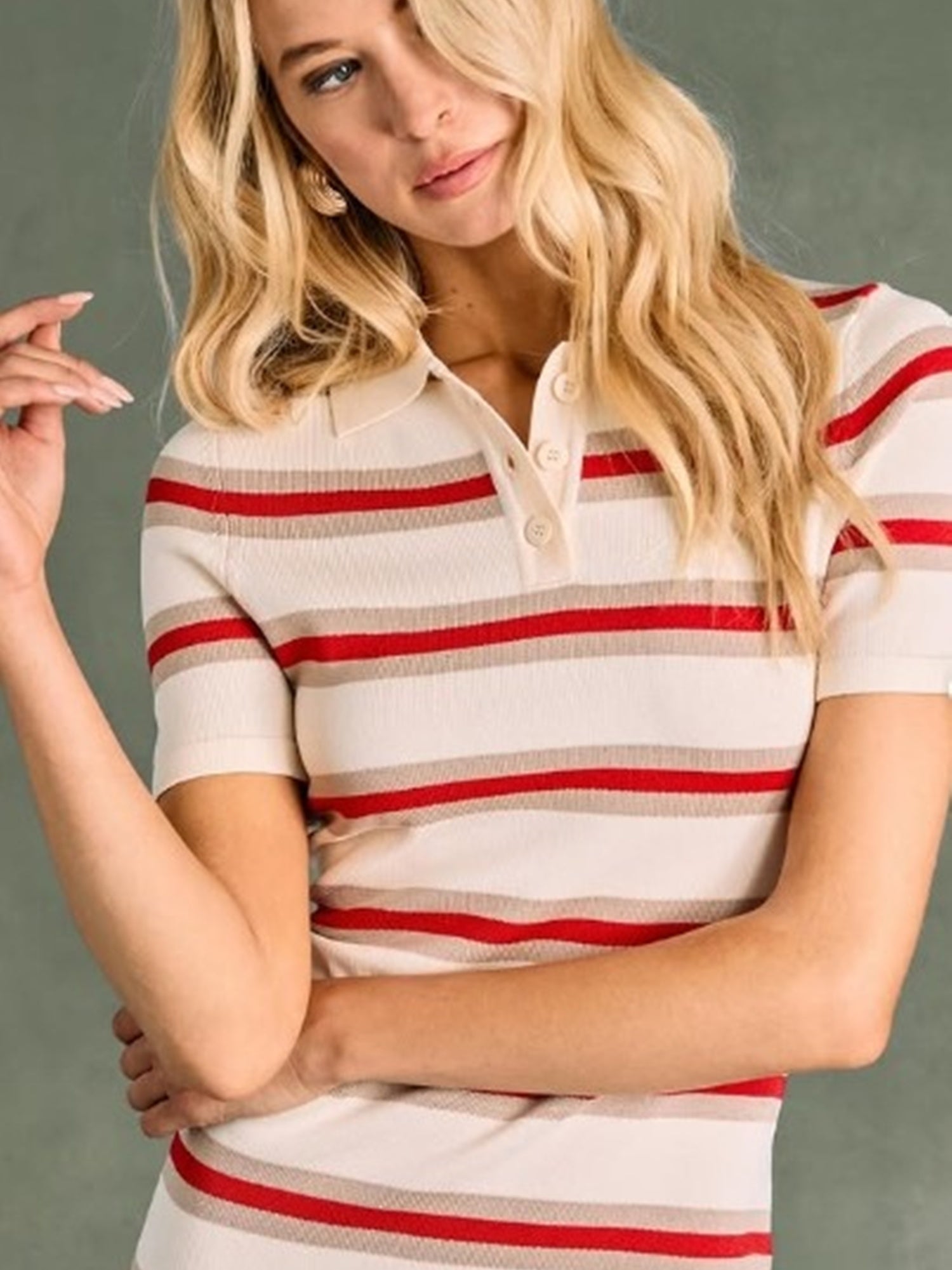 Woman wearing a white and red striped shirt against a gray background