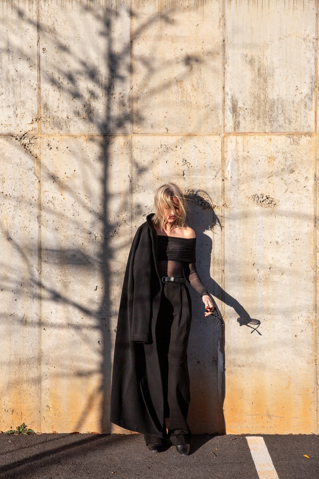 image of a woman wearing the seroya rosa top and sonya pants with the house of dagmar relaxed wool coat